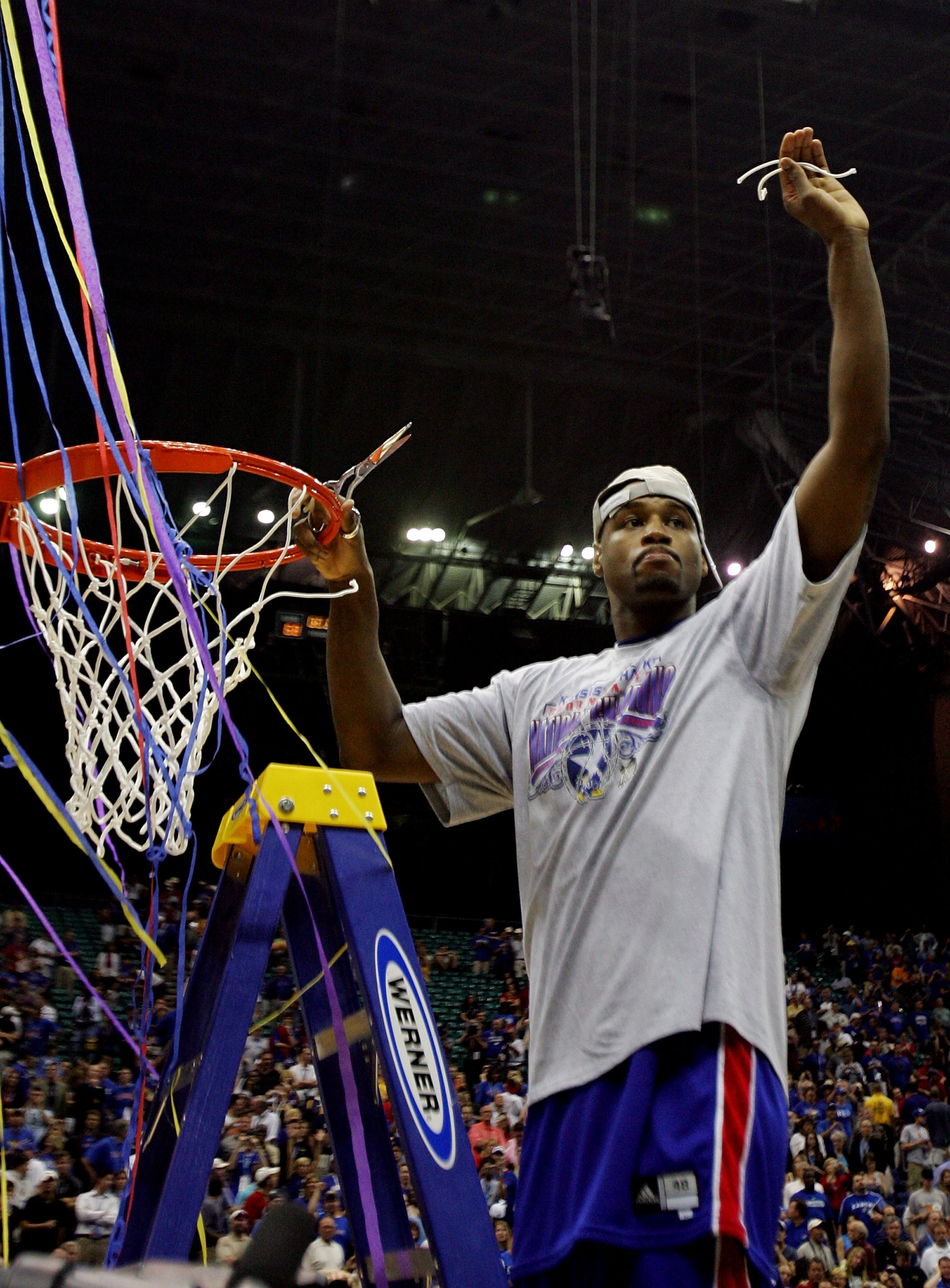 SAN ANTONIO - APRIL 07:  Darnell Jackson #32 of the Kansas Jayhawks celebrates by cutting down the nets after defeating the Memphis Tigers 75-68 in overtime during the 2008 NCAA Men's National Championship game at the Alamodome on April 7, 2008 in San Ant