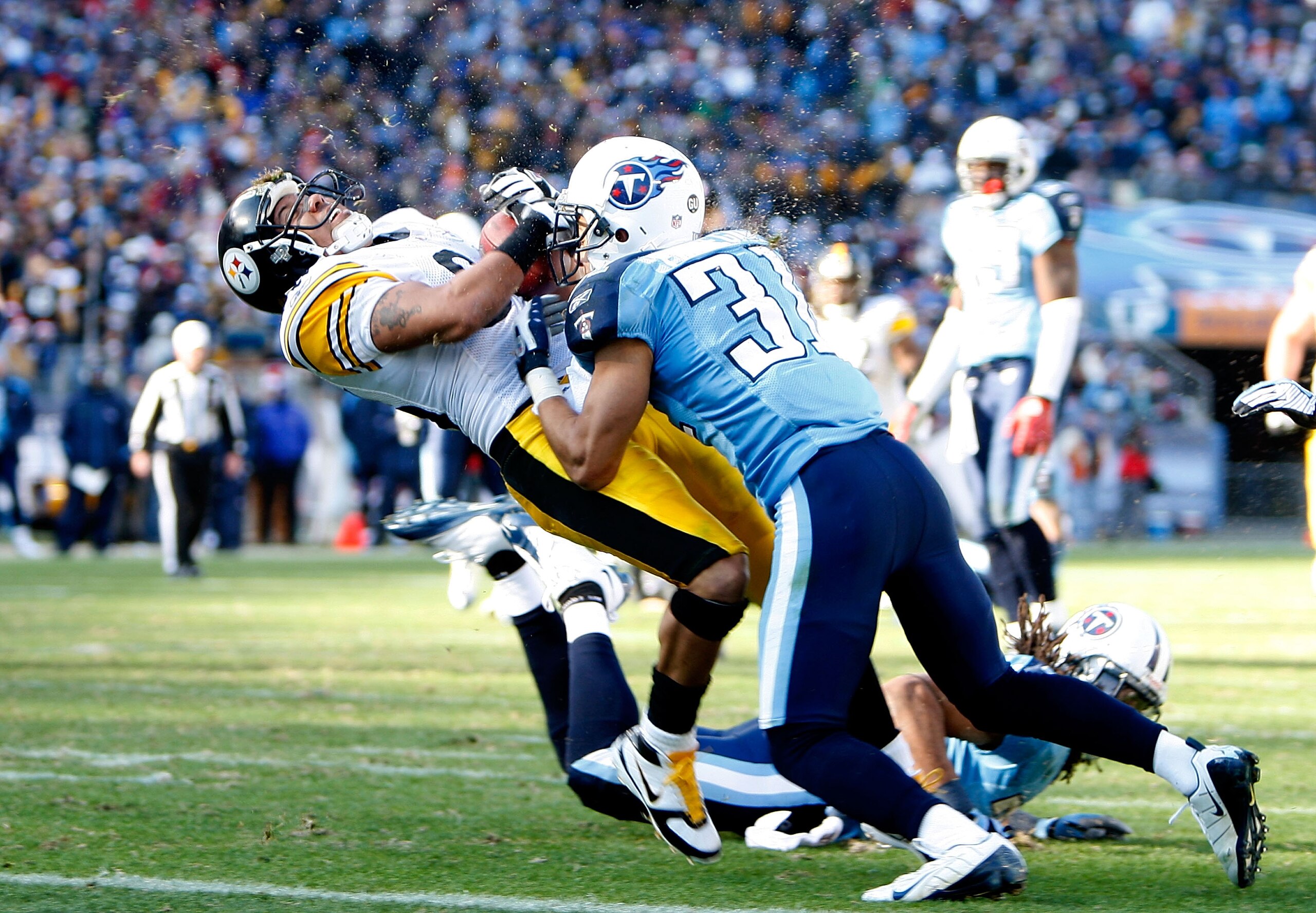 NASHVILLE, TN - DECEMBER 21:  Hines Ward #86 of the Pittsburgh Steelers is hit hard by Cortland Finnegan #31 of the Tennessee Titans as he scores a touchdown during their game on December 21, 2008 at LP Field in Nashville, Tennessee.  (Photo by Streeter L