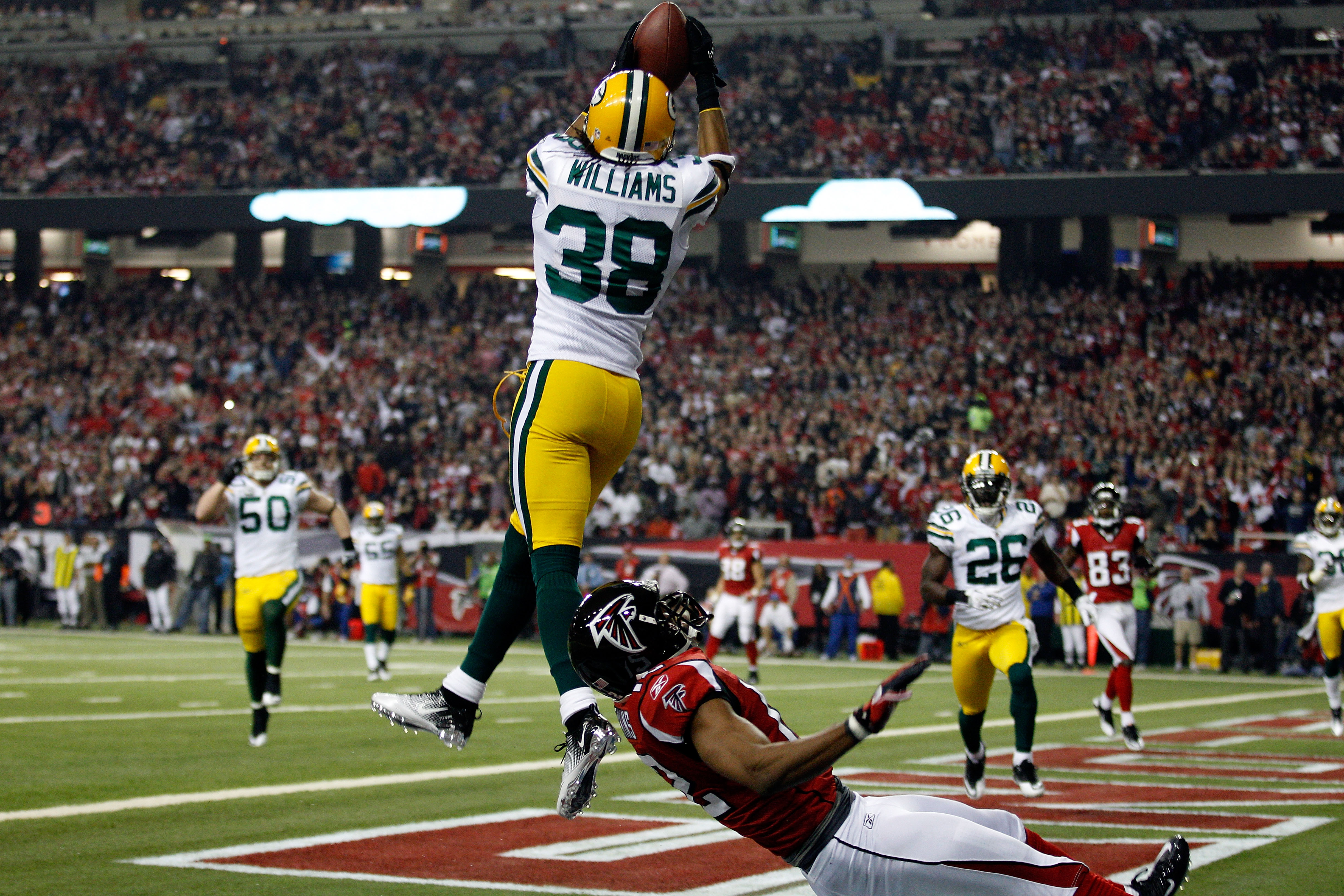 ATLANTA, GA - JANUARY 15:  Tramon Williams #38 of the Green Bay Packers intercepts a pass in the endzone against Michael Jenkins #12 of the Atlanta Falcons during their 2011 NFC divisional playoff game at Georgia Dome on January 15, 2011 in Atlanta, Georg