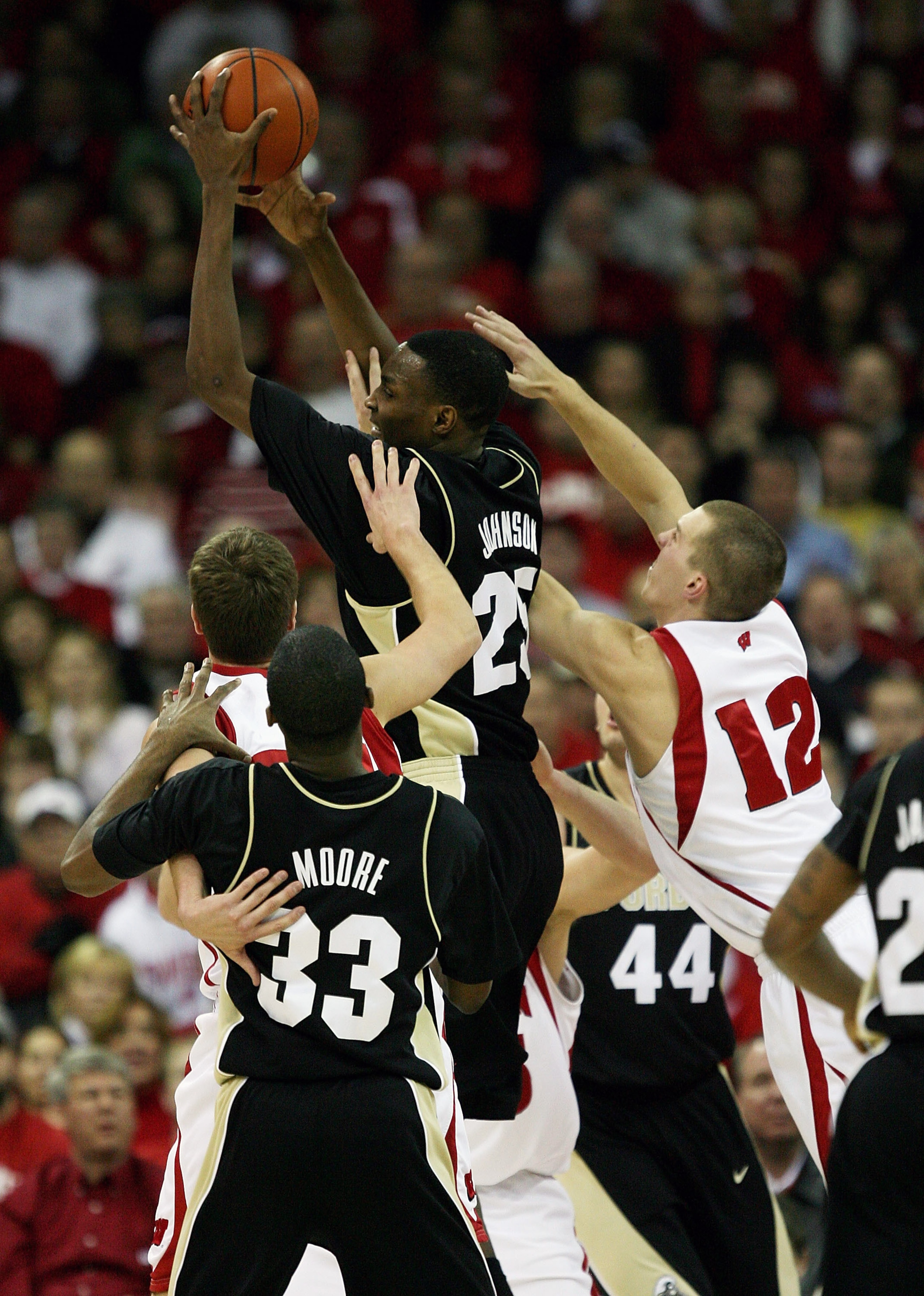 MADISON, WI - JANUARY 27: JaJuan Johnson #25 of the Purdue Boilermakers leaps to pull down a rebound against Jason Bohannon #12 of the Wisconsin Badgers at the Kohl Center January 27, 2009 in Madison, Wisconsin. (Photo by Jonathan Daniel/Getty Images)