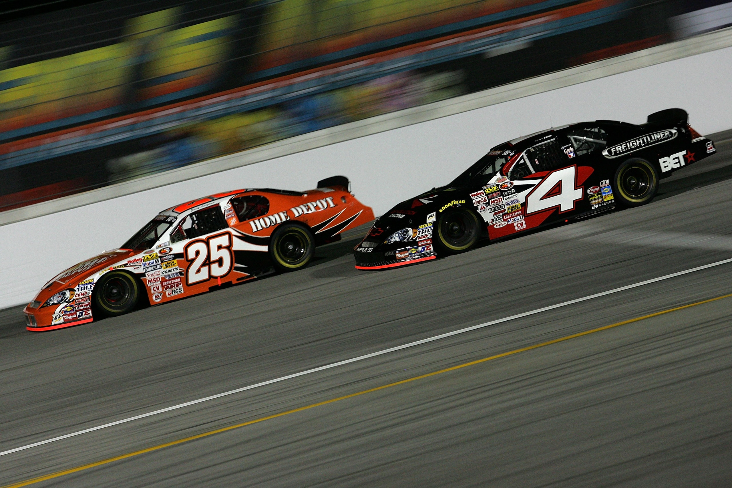 IRWINDALE, CA - JANUARY 30:  Joey Logano, driver of the #25 Home Depot Toyota, and Sergio Pena, driver of the #4 Freightliner Chevrolet, drive during the NASCAR Toyota All Star Showdown at Toyota Speedway At Irwindale on Saturday January 30, 2010 in Irwin