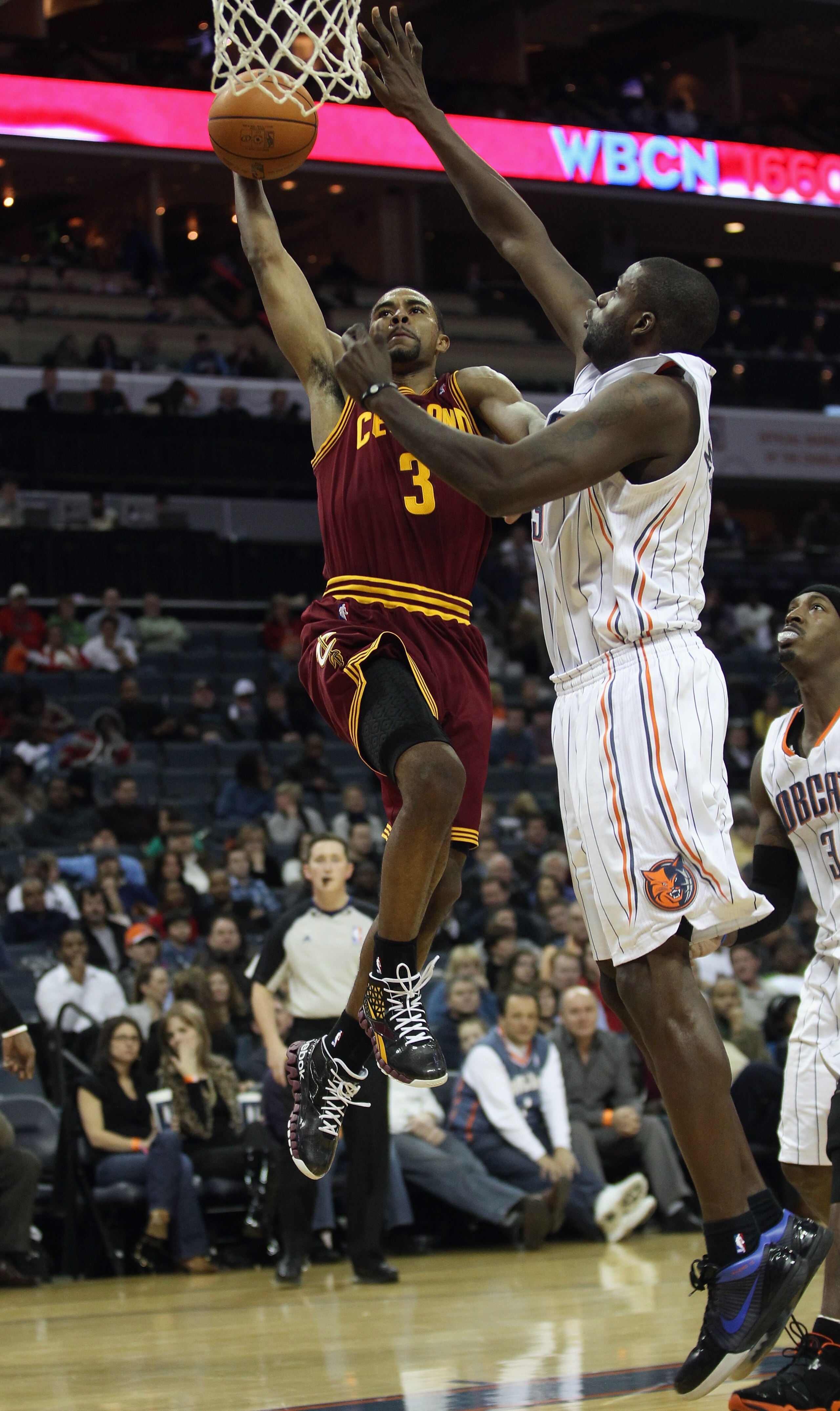 CHARLOTTE, NC - DECEMBER 29: Ramon Sessions #3 of the Cleveland Cavaliers dunks the ball on Nazr Mohammed #13 of the Charlotte Bobcats during their game at Time Warner Cable Arena on December 29, 2010 in Charlotte, North Carolina. NOTE TO USER: User expr CHARLOTTE, NC - DECEMBER 29: Ramon Sessions #3 of the Cleveland Cavaliers dunks the ball on Nazr Mohammed #13 of the Charlotte Bobcats during their game at Time Warner Cable Arena on December 29, 2010 in Charlotte, North Carolina. NOTE TO USER: User expr