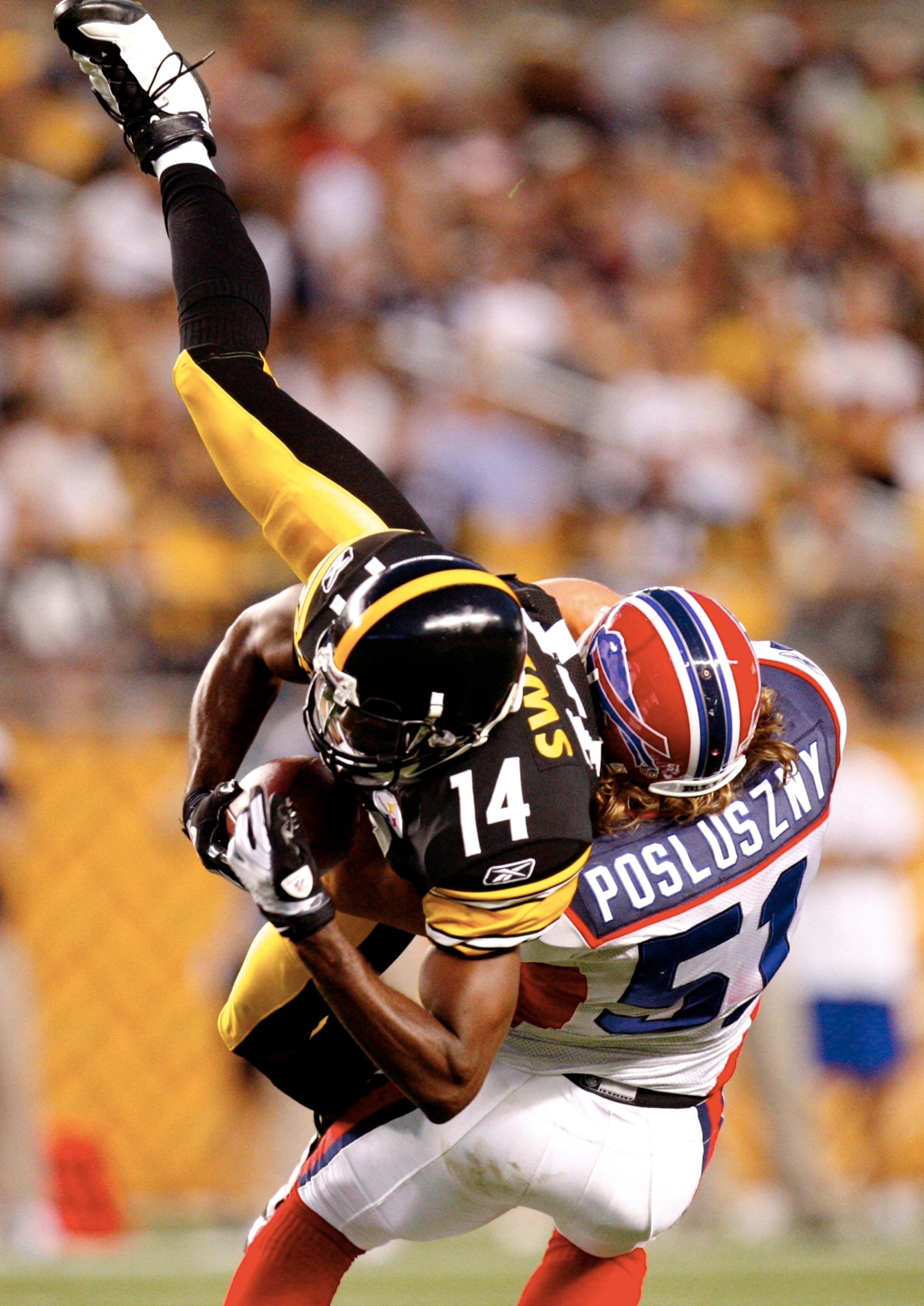 PITTSBURGH - AUGUST 29: Wide Reciver Limas Sweed #14 of the Pittsburgh Steelers makes a frist down catch in the first quarter tackled by Paul Posluszny #51 of the Buffalo Bills at Heinz Field on August 29, 2009 in Pittsburgh, Pennsylvania. (Photo by Grego