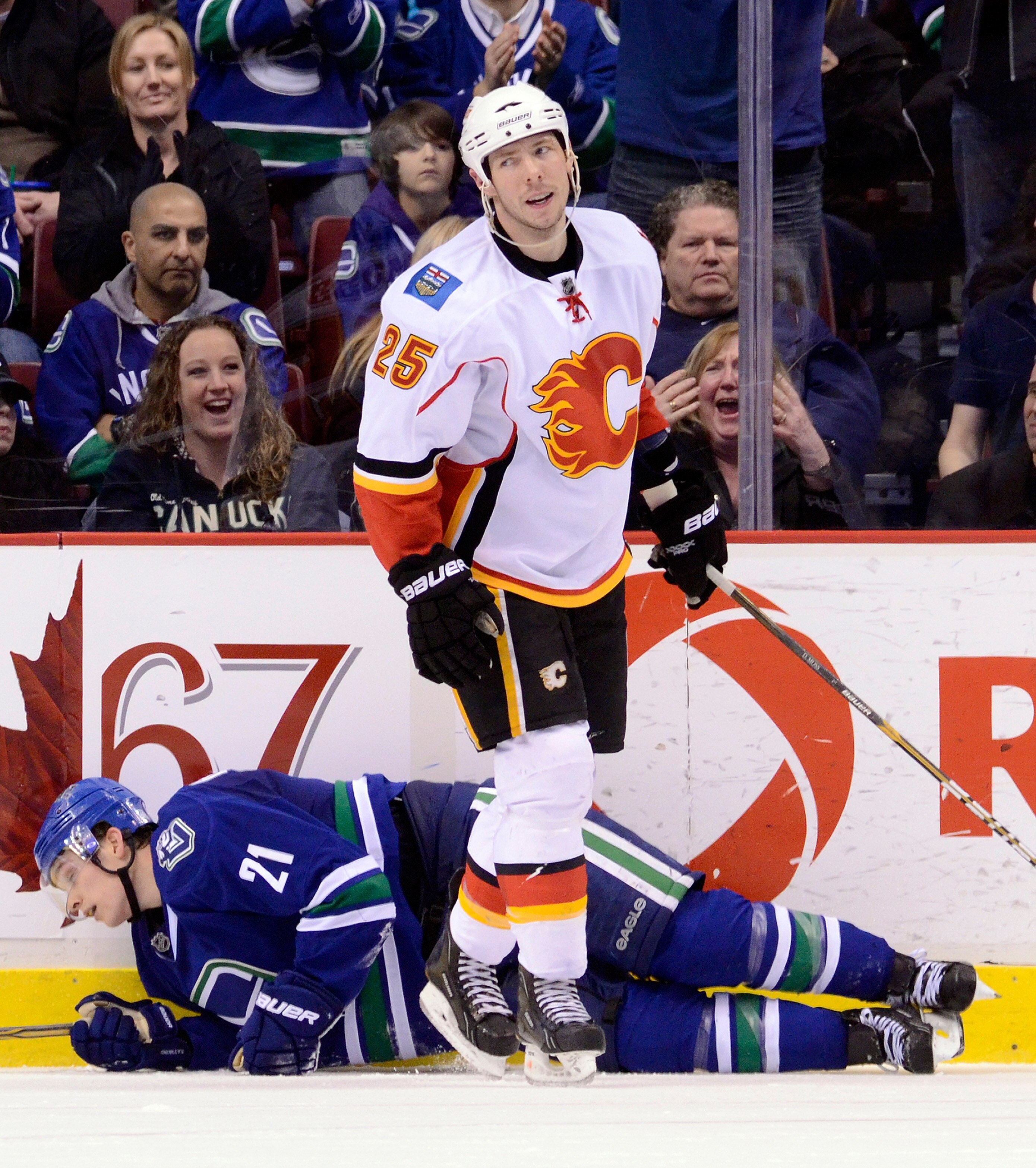 VANCOUVER, CANADA - JANUARY 22: David Moss #25 of the Calgary Flames reacts after getting called for tripping Mason Raymond #21 of the Vancouver Canucks during the third period in NHL action on January 22, 2011 at Rogers Arena in Vancouver, British Columb