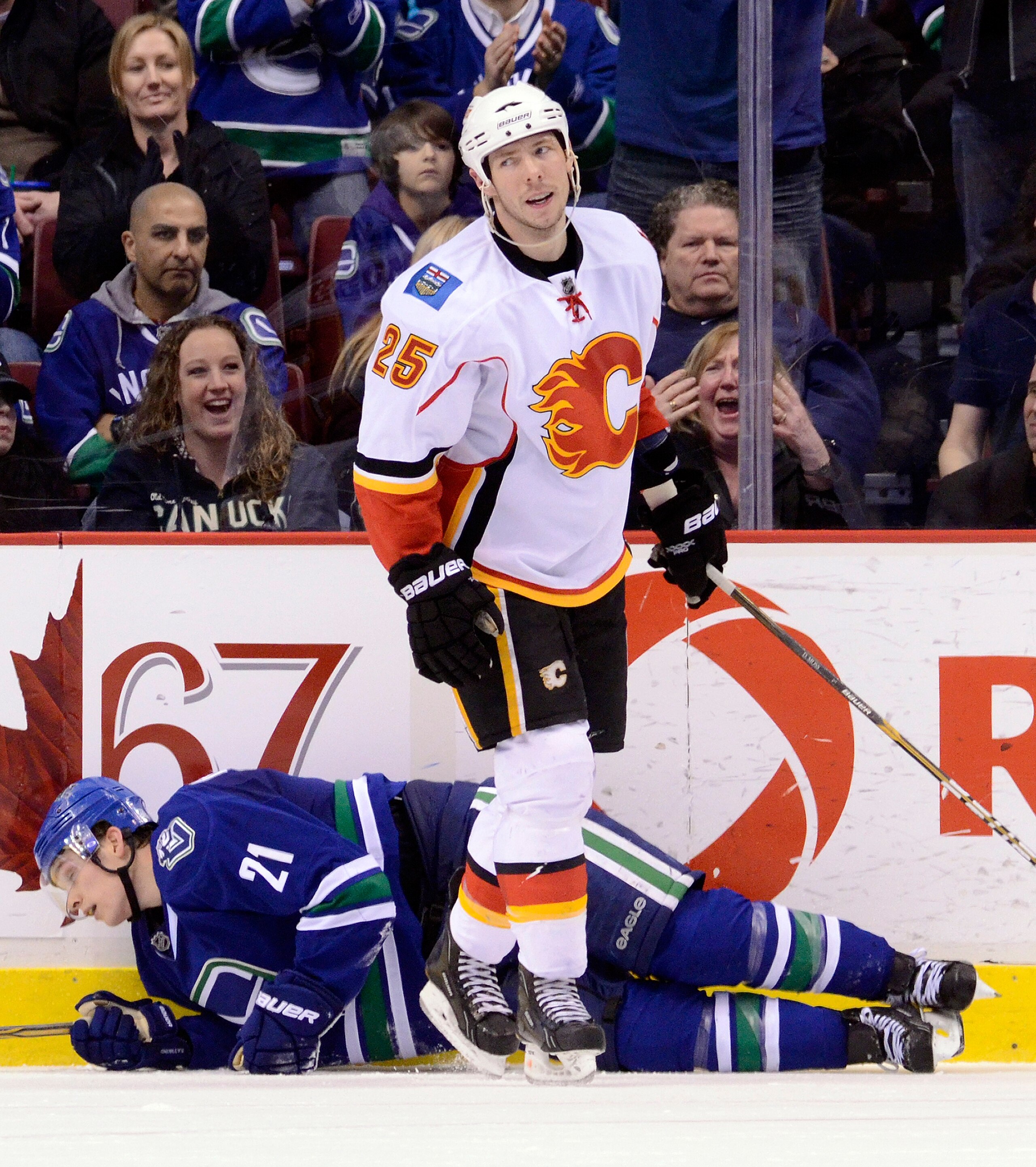 VANCOUVER, CANADA - JANUARY 22: David Moss #25 of the Calgary Flames reacts after getting called for tripping Mason Raymond #21 of the Vancouver Canucks during the third period in NHL action on January 22, 2011 at Rogers Arena in Vancouver, British Columb VANCOUVER, CANADA - JANUARY 22: David Moss #25 of the Calgary Flames reacts after getting called for tripping Mason Raymond #21 of the Vancouver Canucks during the third period in NHL action on January 22, 2011 at Rogers Arena in Vancouver, British Columb