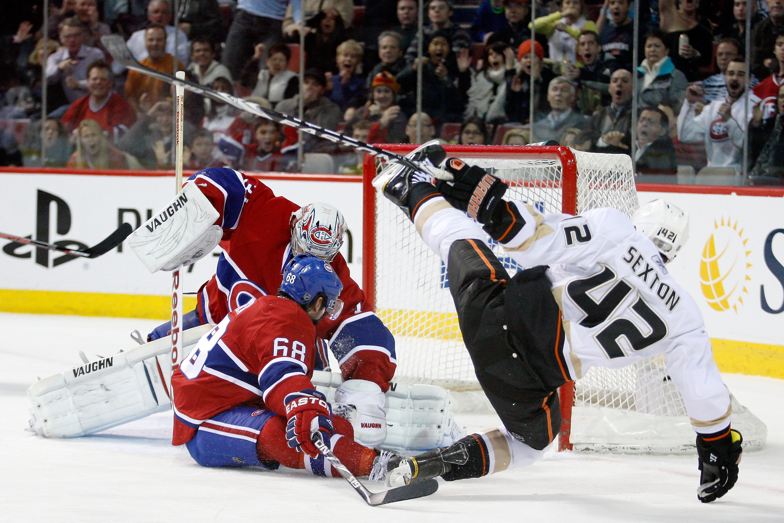 MONTREAL, CANADA - JANUARY 22: Carey Price #31 of the Montreal Canadiens covers up the loose puck on an attempt by Dan Sexton #42 of the Anaheim Ducks during the NHL game at the Bell Centre on January 22, 2011 in Montreal, Quebec, Canada. The Ducks defe MONTREAL, CANADA - JANUARY 22: Carey Price #31 of the Montreal Canadiens covers up the loose puck on an attempt by Dan Sexton #42 of the Anaheim Ducks during the NHL game at the Bell Centre on January 22, 2011 in Montreal, Quebec, Canada. The Ducks defe