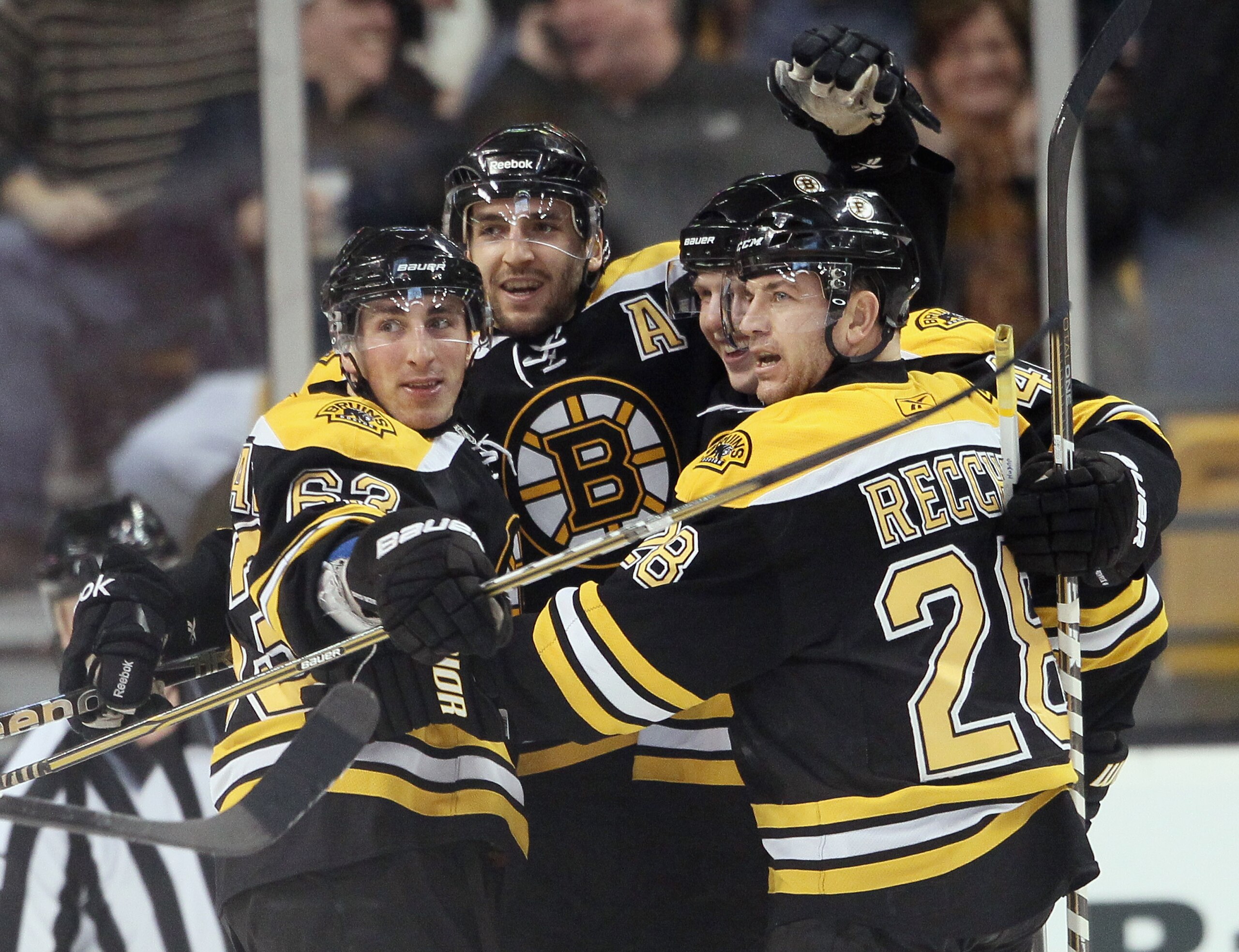 BOSTON, MA - JANUARY 13: Patrice Bergeron #37 of the Boston Bruins is congratulated by teammates Brad Marchand #63,Mark Recchi #28 and Steven Kampfer #47 after Bergeron scored in the second period against the Philadelphia Flyers on January 13, 2011 at th BOSTON, MA - JANUARY 13: Patrice Bergeron #37 of the Boston Bruins is congratulated by teammates Brad Marchand #63,Mark Recchi #28 and Steven Kampfer #47 after Bergeron scored in the second period against the Philadelphia Flyers on January 13, 2011 at th