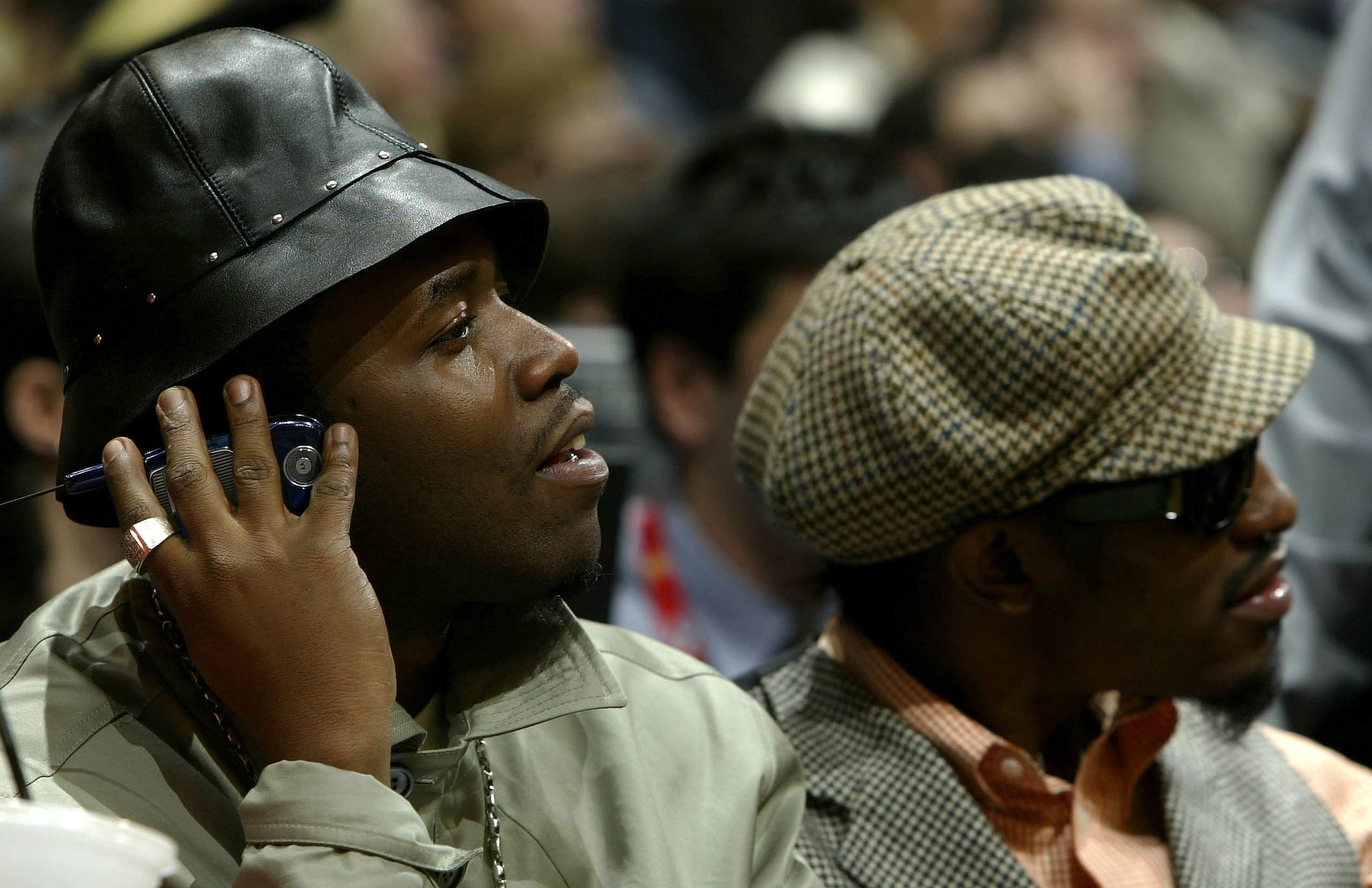 LOS ANGELES - FEBRUARY 15:  (L-R) Big Boi and Andre 3000 of Outkast watch the 2004 NBA All-Star Game on February 15, 2004 at the Staples Center in Los Angeles, California.  NOTE TO USER: User expressly acknowledges and agrees that, by downloading and/or u