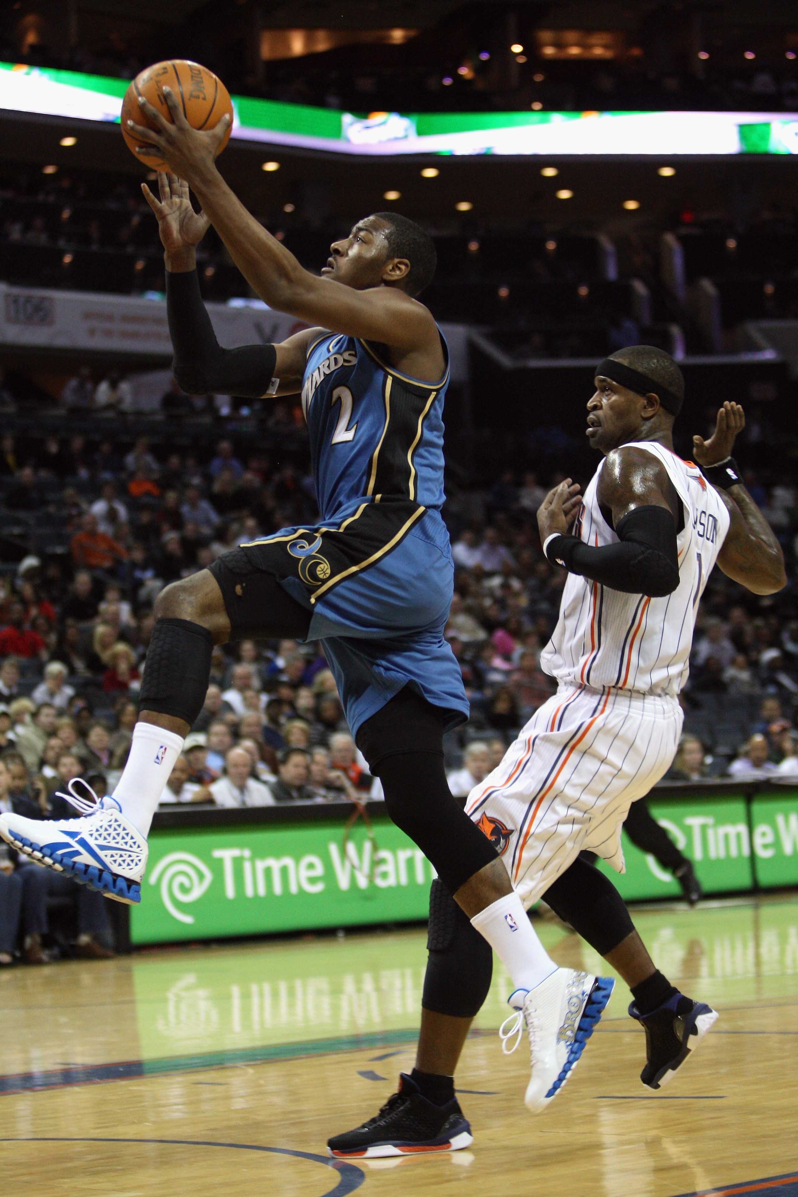 SCHARLOTTE, NC - JANUARY 08:  John Wall #1 of the Washington Wizards drives to the basket against Stephen Jackson #1 the Charlotte Bobcats during their game at Time Warner Cable Arena on January 8, 2011 in Charlotte, North Carolina. NOTE TO USER: User exp