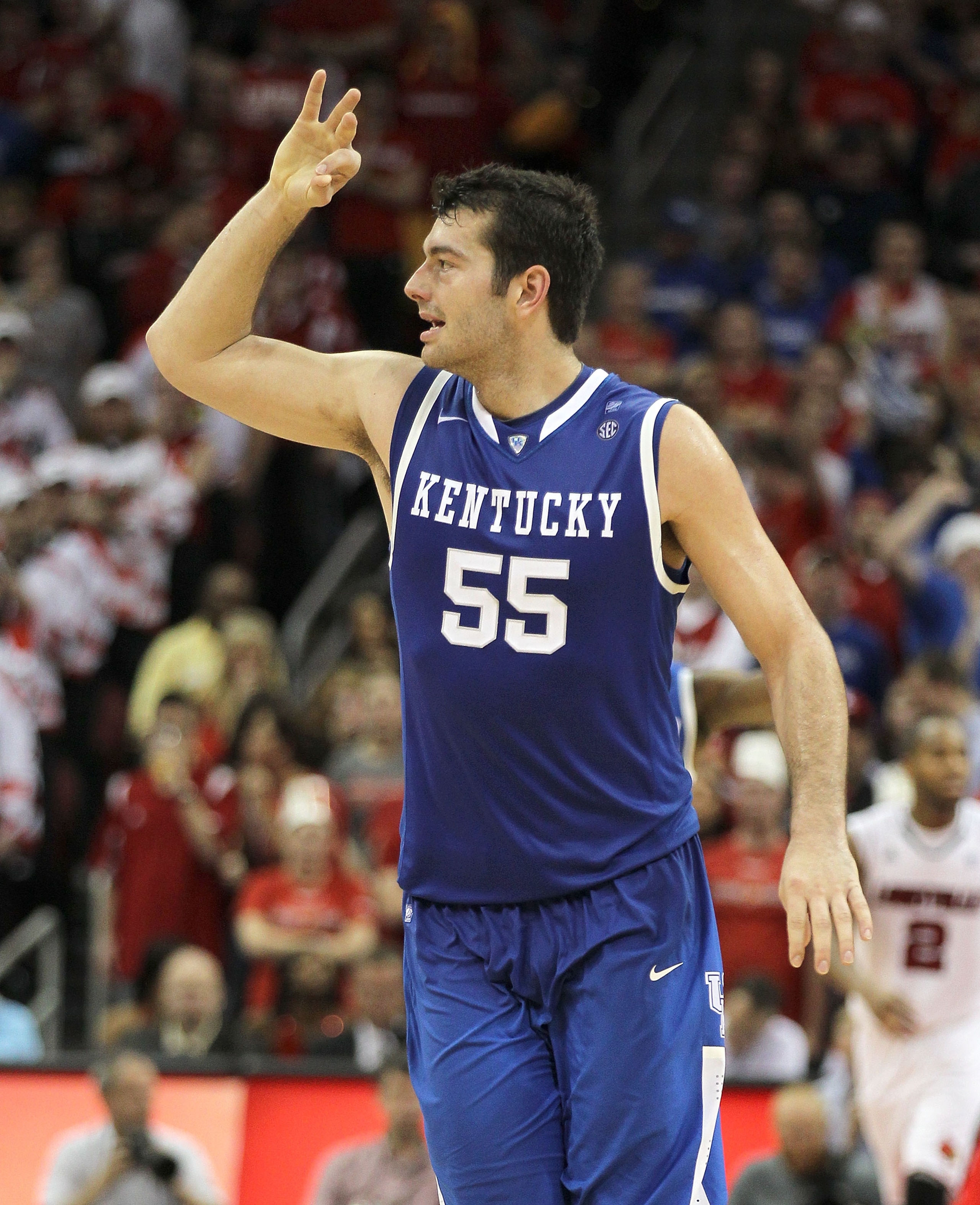 LOUISVILLE, KY - DECEMBER 31:  Josh Harrellson #55 of the Kentucky Wildcats celebrates after making a three point shot during the game against the Louisville Cardinals at the KFC Yum! Center on December 31, 2010 in Louisville, Kentucky. Kentucky won 78-63