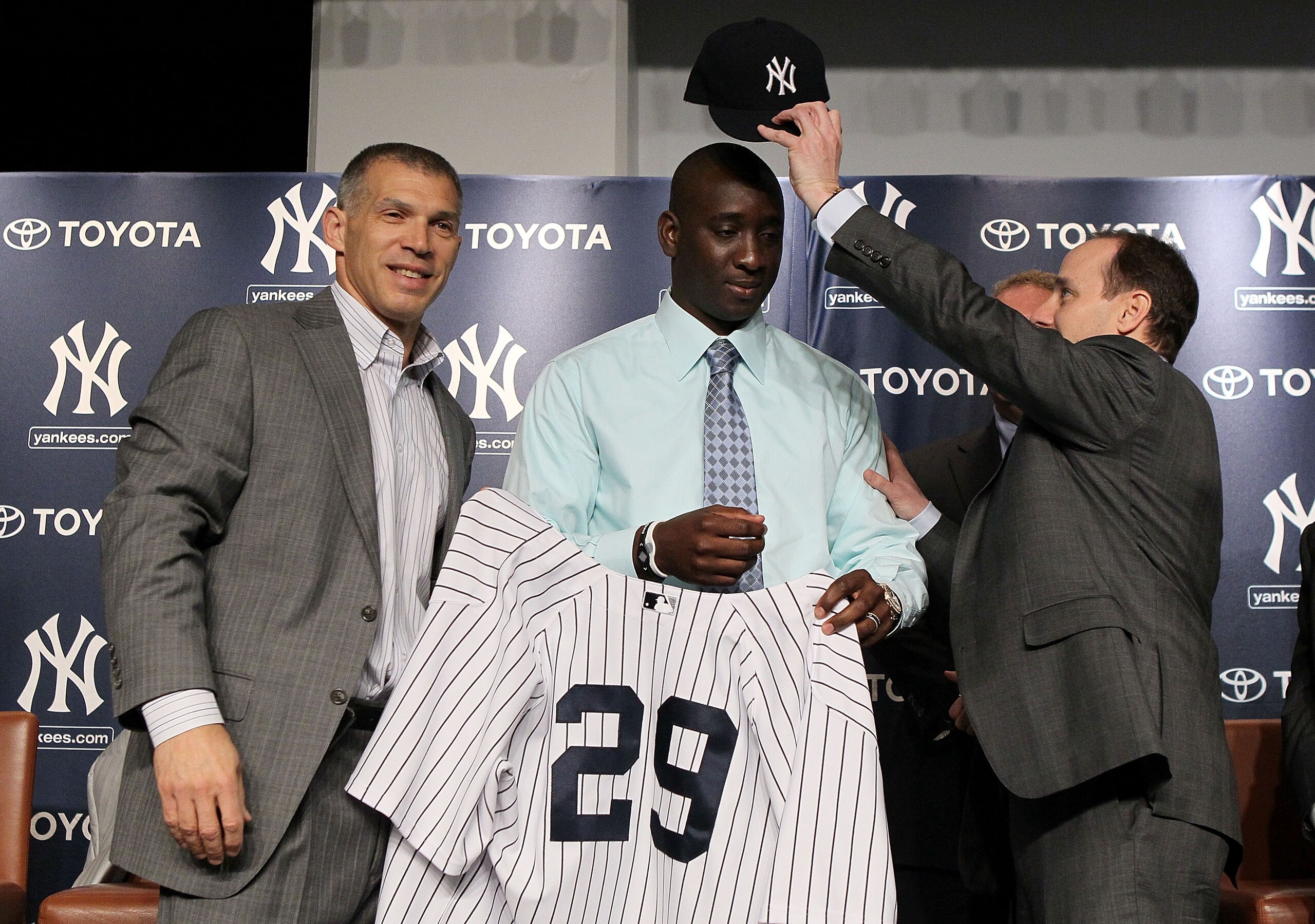 NEW YORK, NY - JANUARY 19:  Rafael Sorianoof the New York Yankees is presented his jersey and cap from manager Joe Girardi (L) and general manager Brian Cashman during his introduction press conference on January 19, 2011 at Yankee Stadium in the Bronx bo
