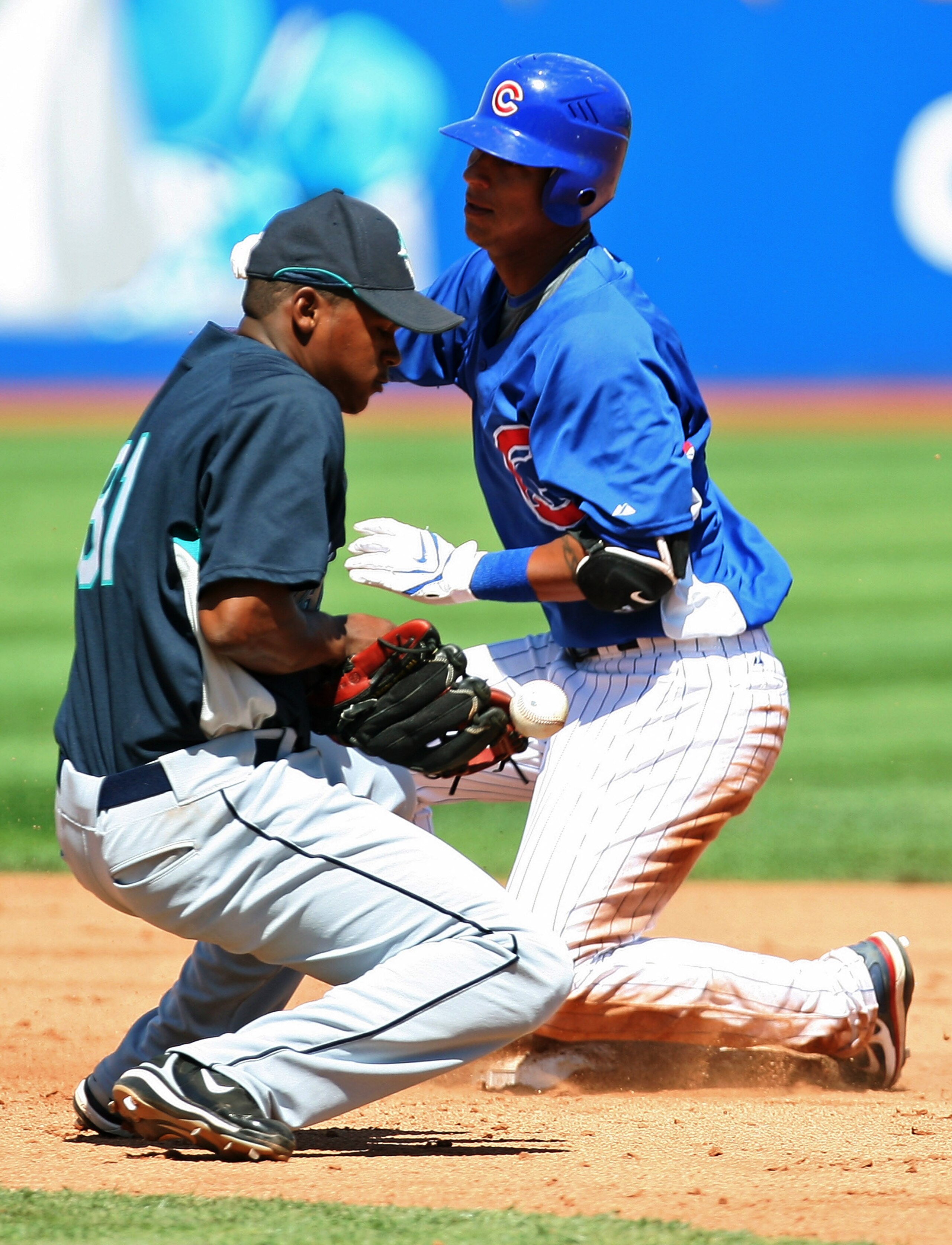 LAS VEGAS - MARCH 29:  Ronny Cedeno #5 of the Chicago Cubs gets safely to second base for a double ahead of the throw to shortstop Carlos Triunfel #81 of the Seattle Mariners during the sixth inning of their exhibition game at Cashman Field March 29, 2008