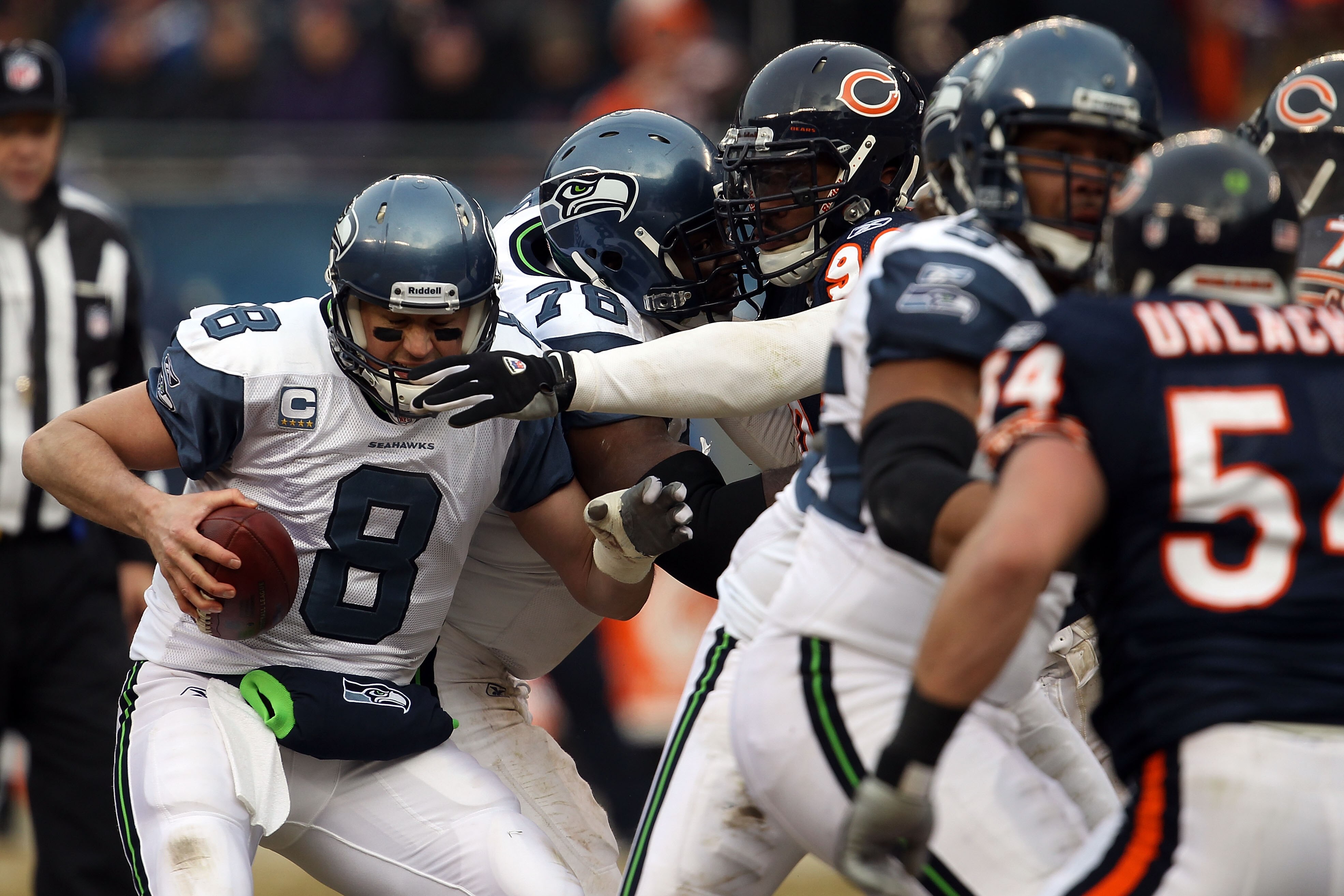 CHICAGO, IL - JANUARY 16:  Quarterback Matt Hasselbeck #8 of the Seattle Seahawks attempts to avoid a sack by Julius Peppers #90 of the Chicago Bears in the second half in the 2011 NFC divisional playoff game at Soldier Field on January 16, 2011 in Chicag