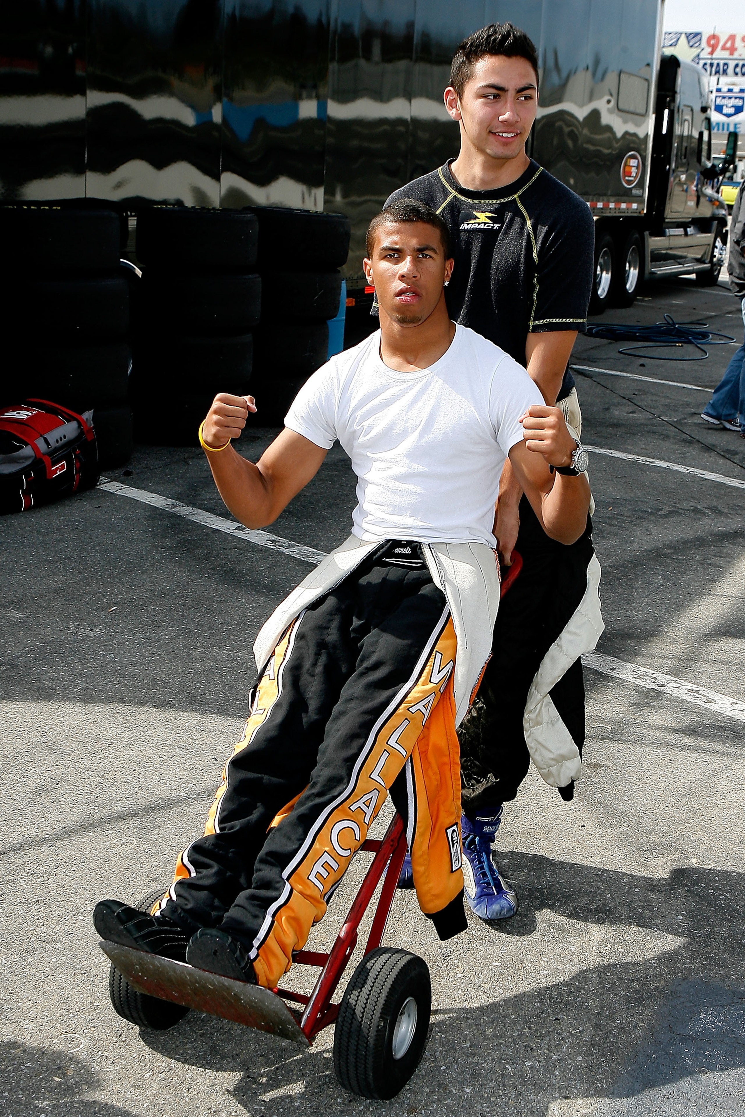 RADFORD, VA - OCTOBER 18:  Darrell Wallace Jr., 16, of Concord, NC is carted around by Sergio Pena ,17, of Catharpin, VA while waiting their turns to drive at the NASCAR Drive for Diversity Combine at Motor Mile Speedway on October 18, 2010 in Radford, Vi