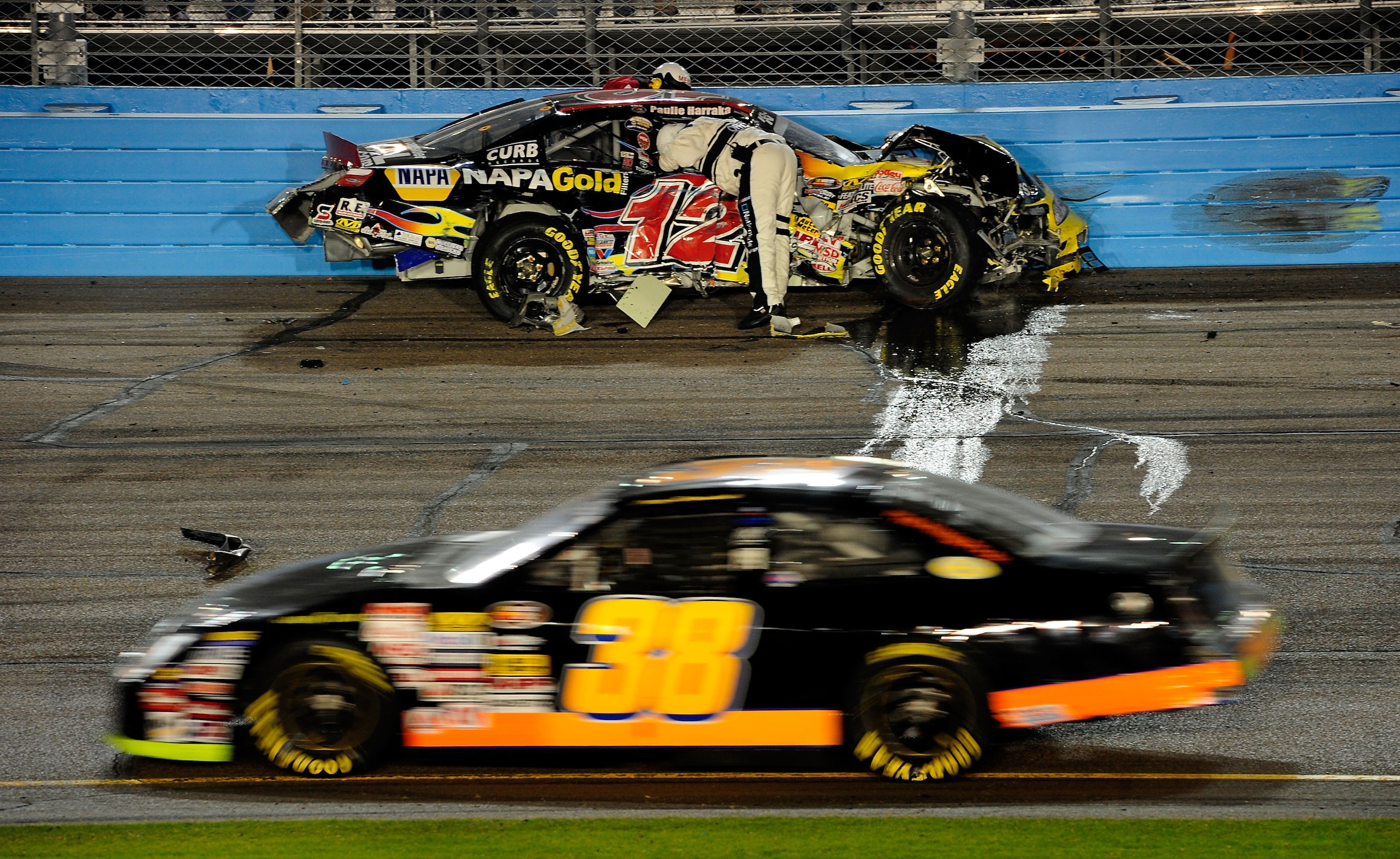 AVONDALE, AZ - NOVEMBER 13:  Safety workers check on Paulie Harraka #12 after a crash during the NASCAR K&N Pro Series 3 Amigos Tequila 125 at Phoenix International Raceway on November 13, 2010 in Avondale, Arizona.  (Photo by Robert Laberge/Getty Images