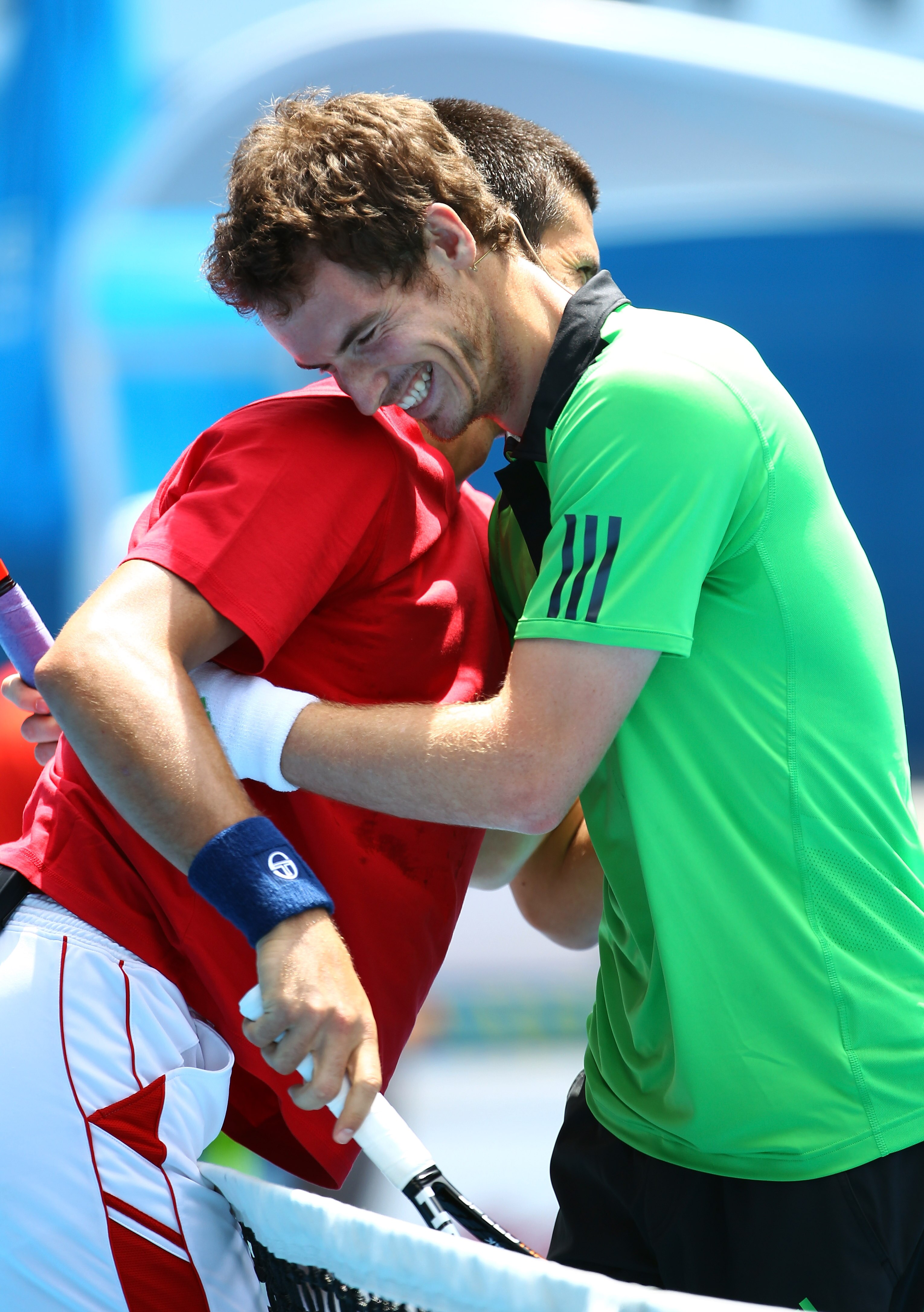 MELBOURNE, AUSTRALIA - JANUARY 16: Novak Djokovic of Serbia and Andy Murray of the United States hug at the net during the 'Rally For Relief' charity exhibition match ahead of the 2011 Australian Open at Melbourne Park on January 16, 2011 in Melbourne, Au