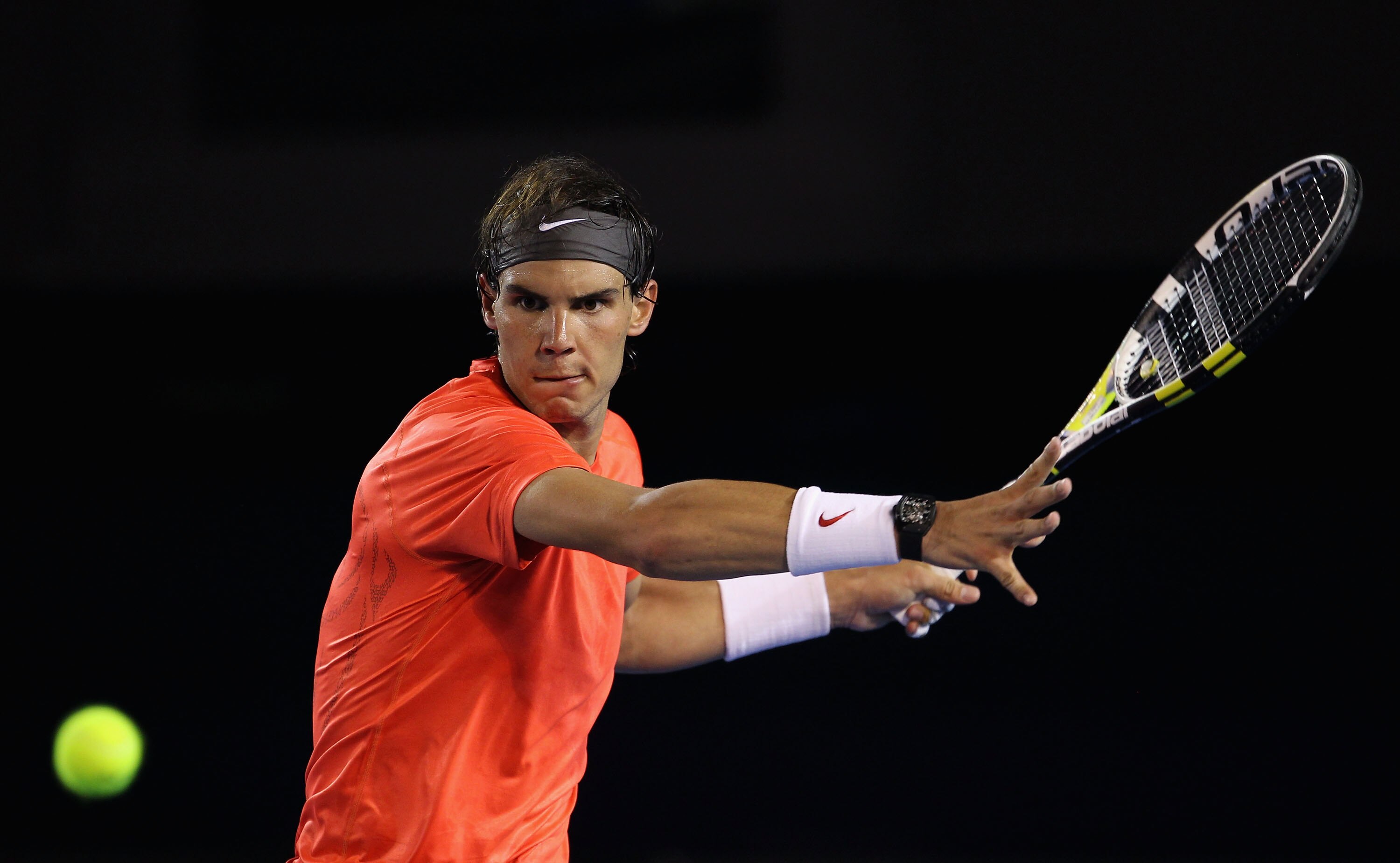 MELBOURNE, AUSTRALIA - JANUARY 22:  Rafael Nadal of Spain plays a forehand in his third round match against Bernard Tomic of Australia during day six of the 2011 Australian Open at Melbourne Park on January 22, 2011 in Melbourne, Australia.  (Photo by Jul