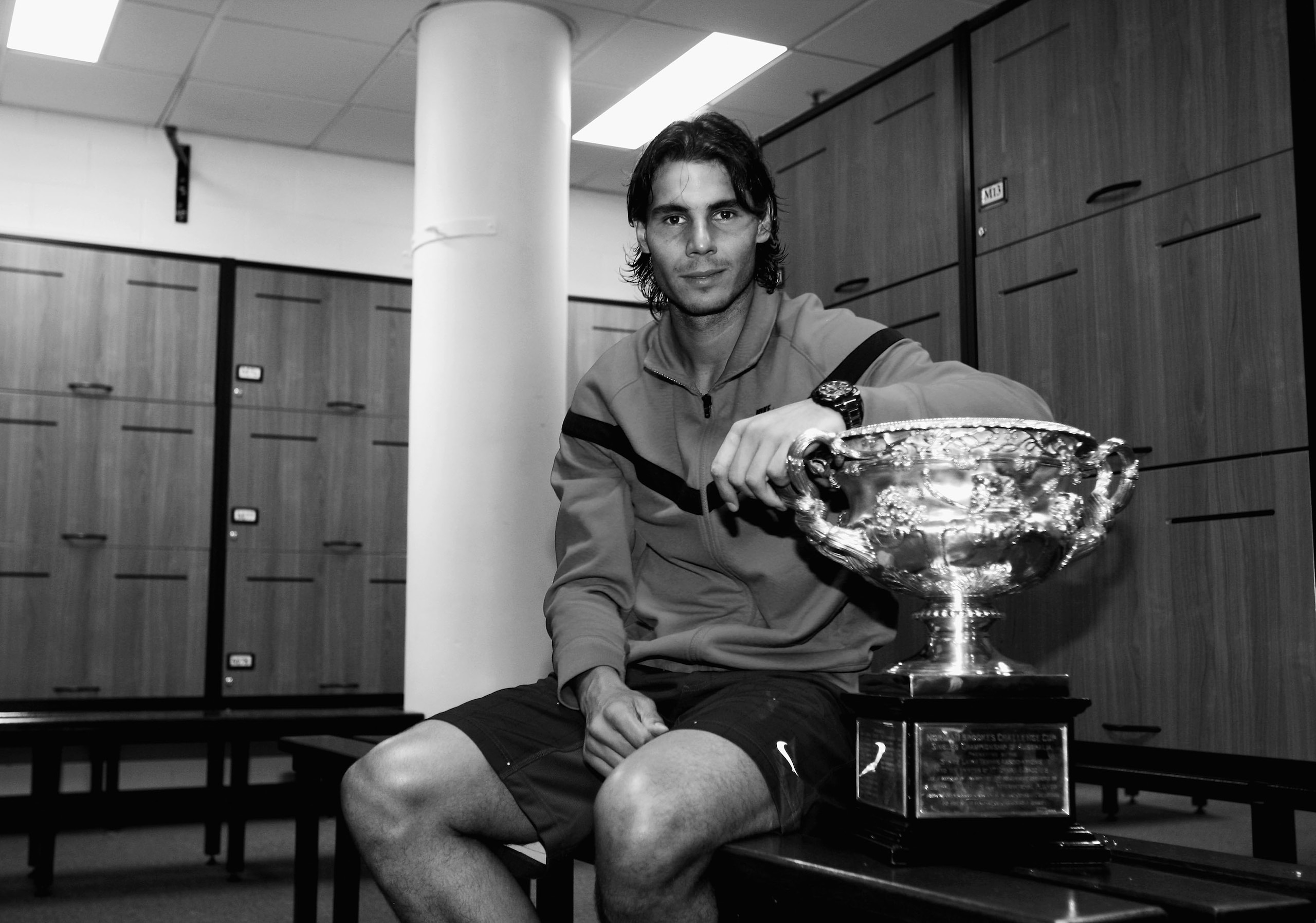 MELBOURNE, AUSTRALIA - FEBRUARY 01:  (EDITORS NOTE: THIS BLACK AND WHITE IMAGE HAS BEEN CONVERTED FROM ORIGINAL COLOUR FILE) Rafael Nadal of Spain poses with the Norman Brookes Challenge Cup in the players locker room after winning the men's final match a