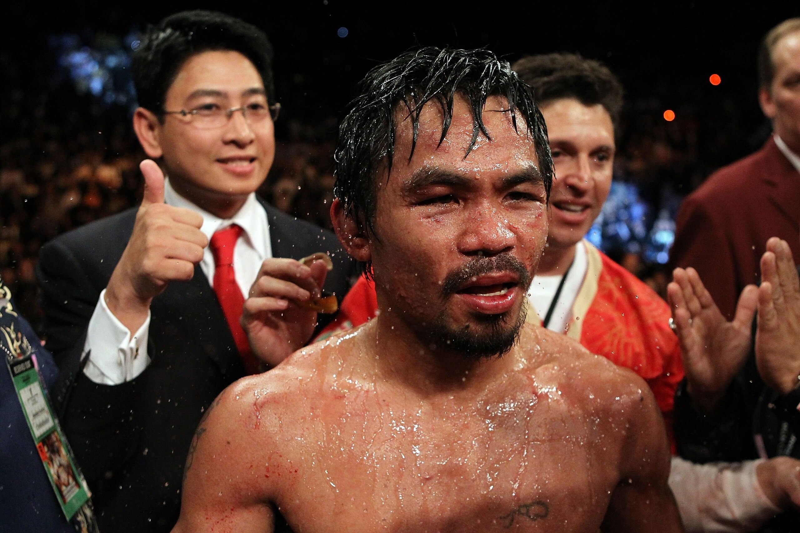 LAS VEGAS - NOVEMBER 14:  (C) Manny Pacquiao celebrates his 12 round TKO victory against Miguel Cotto during their WBO welterweight title fight at the MGM Grand Garden Arena on November 14, 2009 in Las Vegas, Nevada.  (Photo by Al Bello/Getty Images)
