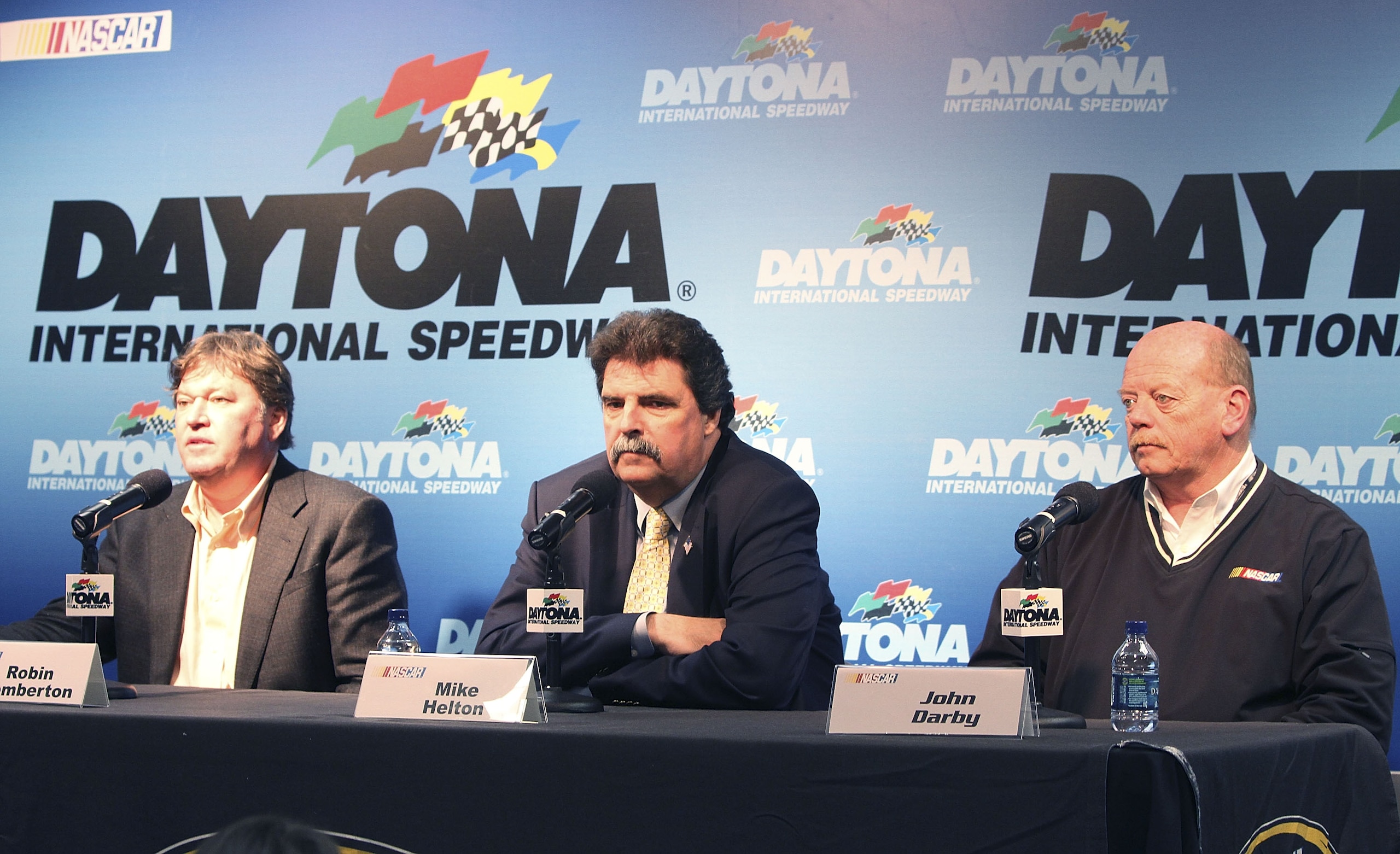 DAYTONA BEACH, FL - JANUARY 21:  NASCAR executives Robin Pemberton, Mike Helton and John Darby address the media at Daytona International Speedway on January 21, 2011 in Daytona Beach, Florida.  (Photo by Jerry Markland/Getty Images for NASCAR)