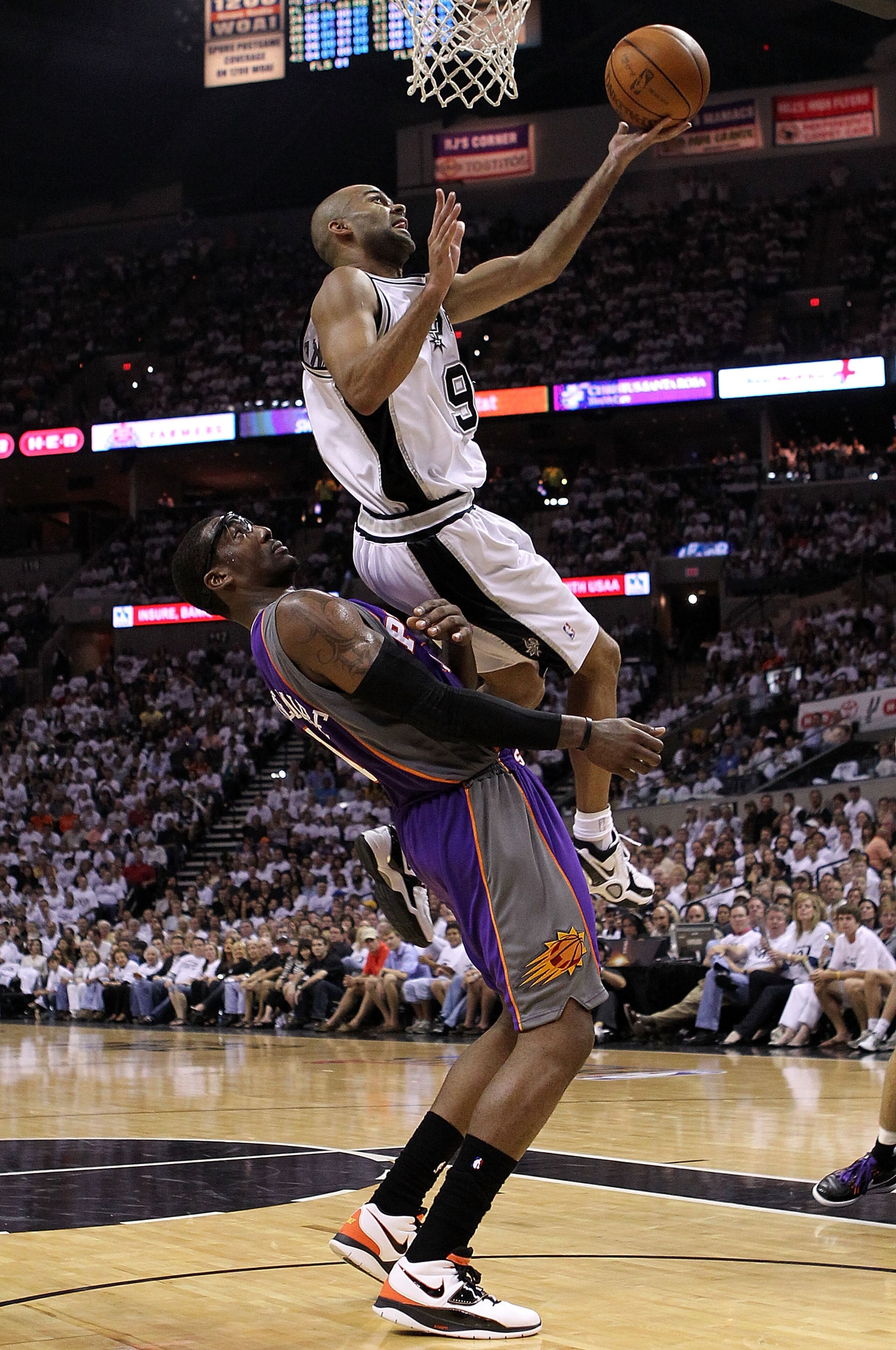 SAN ANTONIO - MAY 07:  Guard Tony Parker #9 of the San Antonio Spurs draws the foul by Amar'e Stoudemire #1 of the Phoenix Suns in Game Three of the Western Conference Semifinals during the 2010 NBA Playoffs at AT&T Center on May 7, 2010 in San Antonio, T