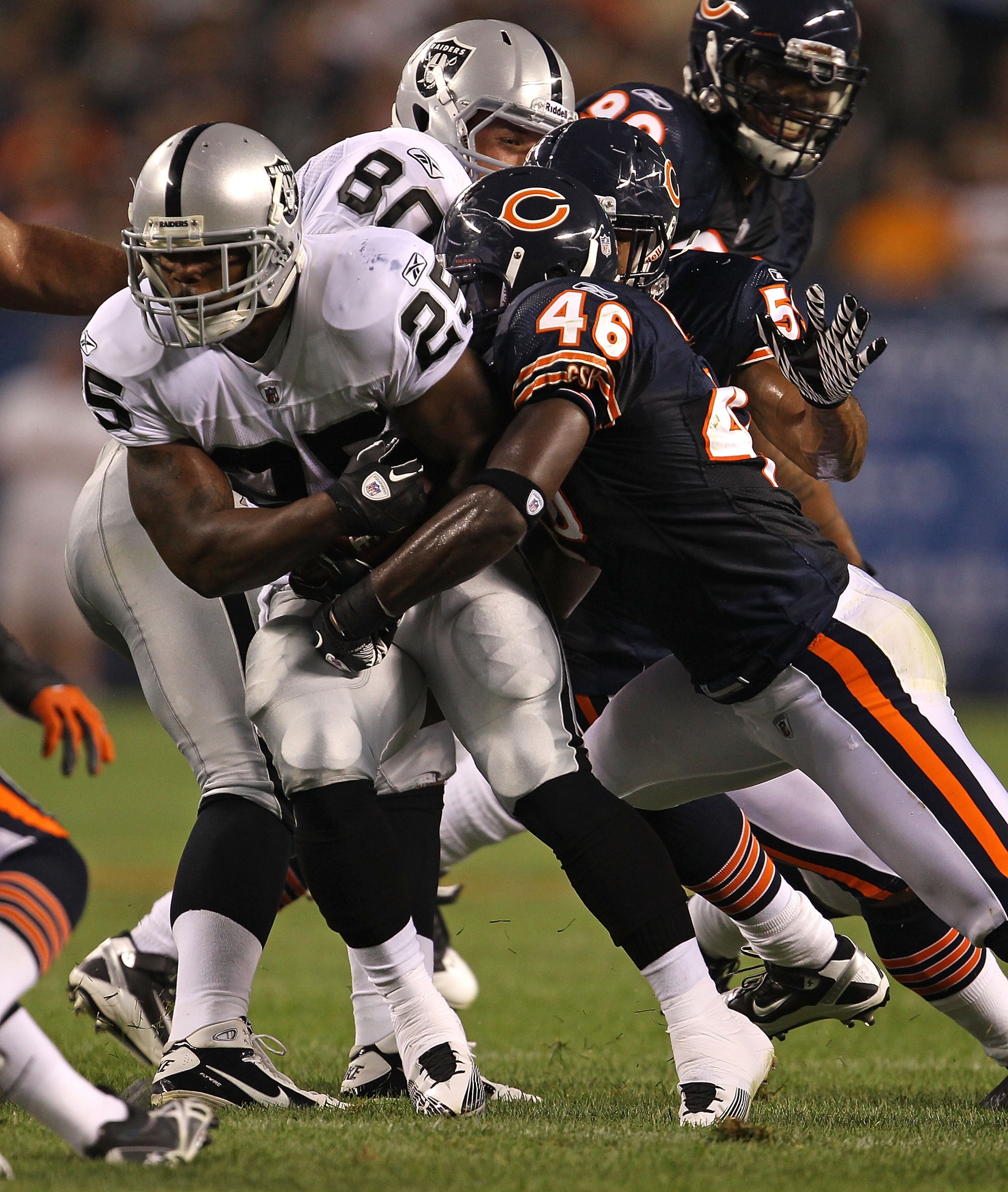 CHICAGO - AUGUST 21: Chris Harris #46 of the Chicago Bears tackles Rock Cartwright #25 of the Oakland Raiders during a preseason game at Soldier Field on August 21, 2010 in Chicago, Illinois. The Raiders defeated the Bears 32-17. (Photo by Jonathan Daniel