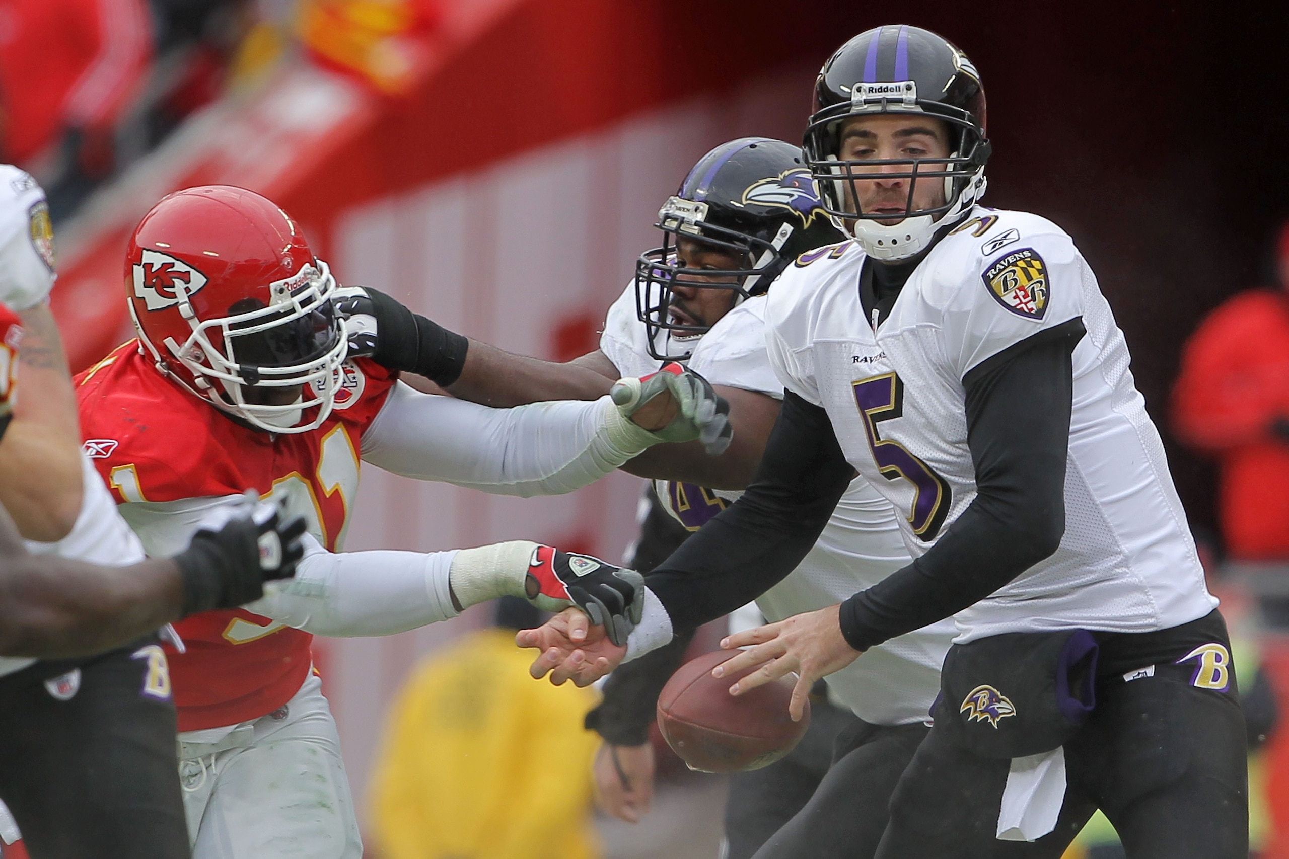 KANSAS CITY, MO - JANUARY 09:  Linebacker Tamba Hali #91 of the Kansas City Chiefs hits the ball out of the hands of quarterback Joe Flacco #5 of the Baltimore Ravens during their 2011 AFC wild card playoff game at Arrowhead Stadium on January 9, 2011 in