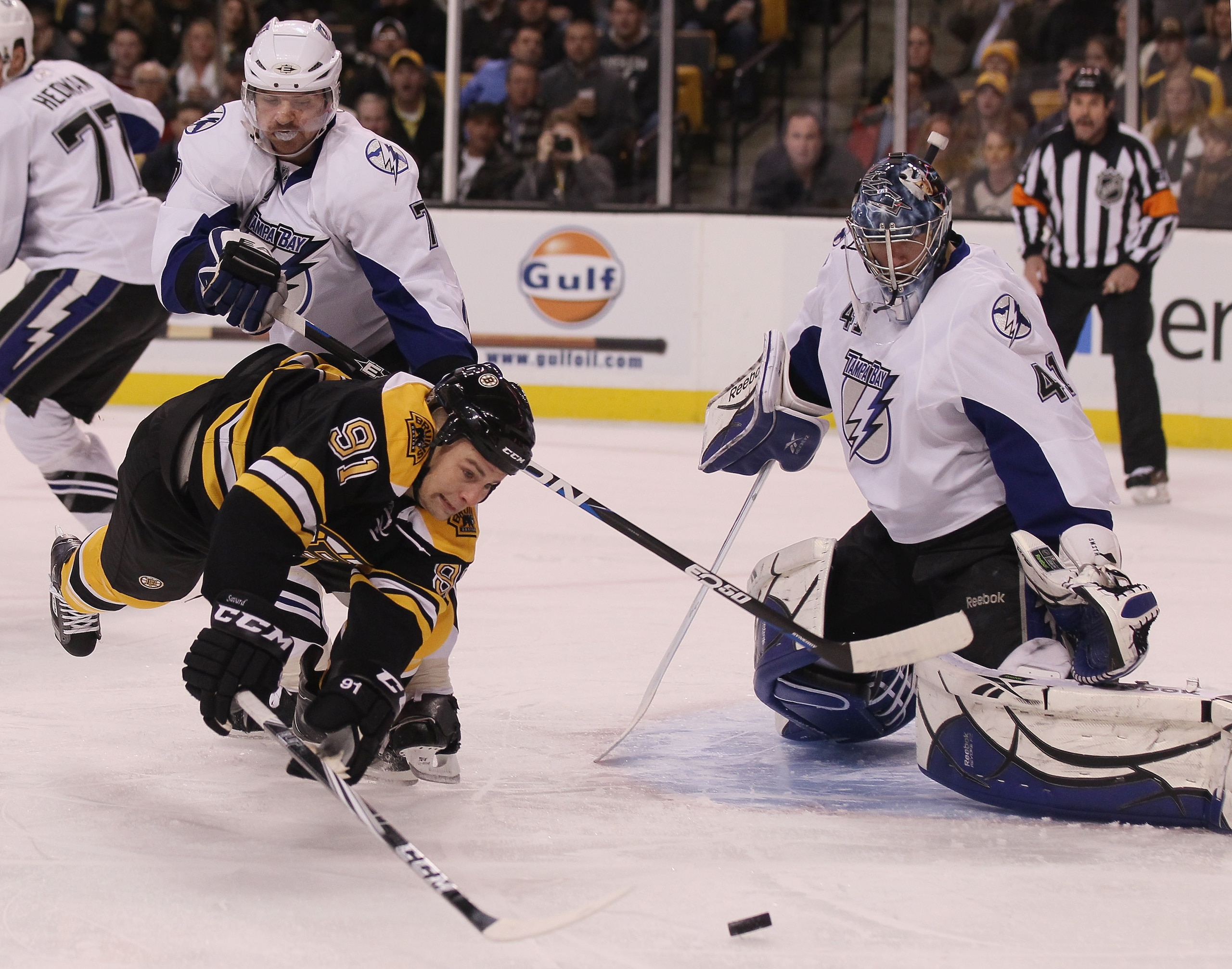 BOSTON, MA - DECEMBER 02:  Marc Savard #91 of the Boston Bruins tries to get a shot past Mike Smith #41 of the Tampa Bay Lightning as Brett Clark #7 of the Lightning defends on December 2, 2010 at the TD Garden in Boston, Massachusetts.  (Photo by Elsa/Ge