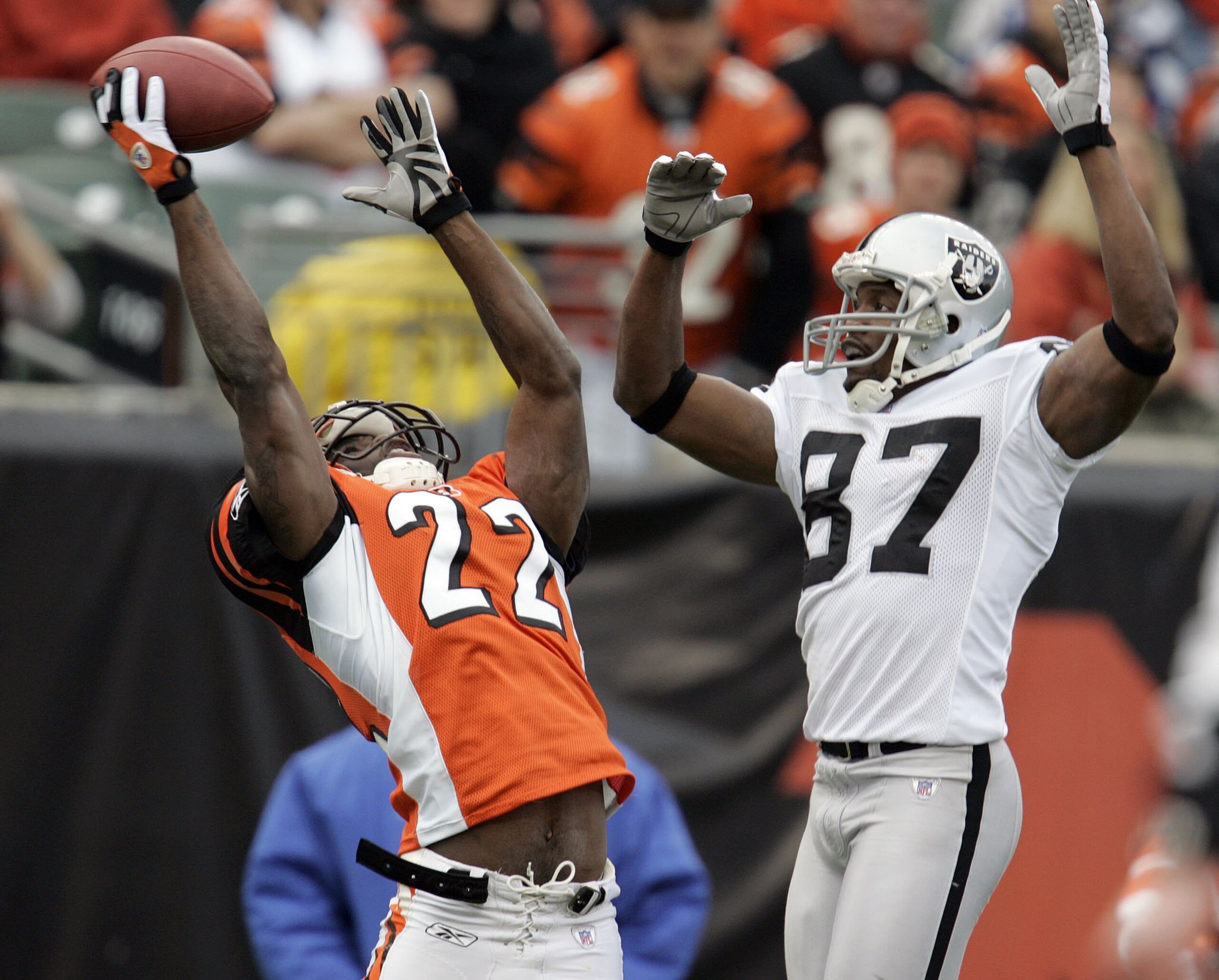 CINCINNATI, OH - DECEMBER 10:  Jonathan Joseph #22 of the Cincinnati Bengals almost intercepts a pass intended for Alvis Whitted #87 of the Oakland Raiders during the second quarter on December 10, 2006 at Paul Brown Stadium in Cincinnati, Ohio.  The Beng