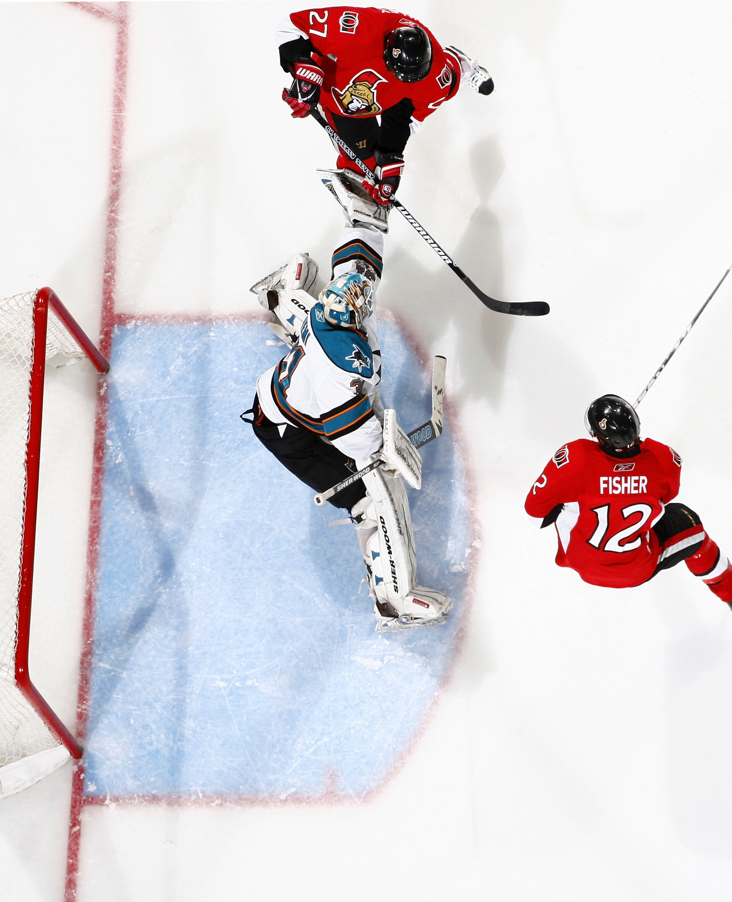 OTTAWA, ON - DECEMBER 02:  Antti Niemi #31 of the San Jose Sharks makes a glove save with Alex Kovalev #27 of the Ottawa Senators swats at the puck in a game at Scotiabank Place on December 2, 2010 in Ottawa, Ontario, Canada.  (Photo by Phillip MacCallum/