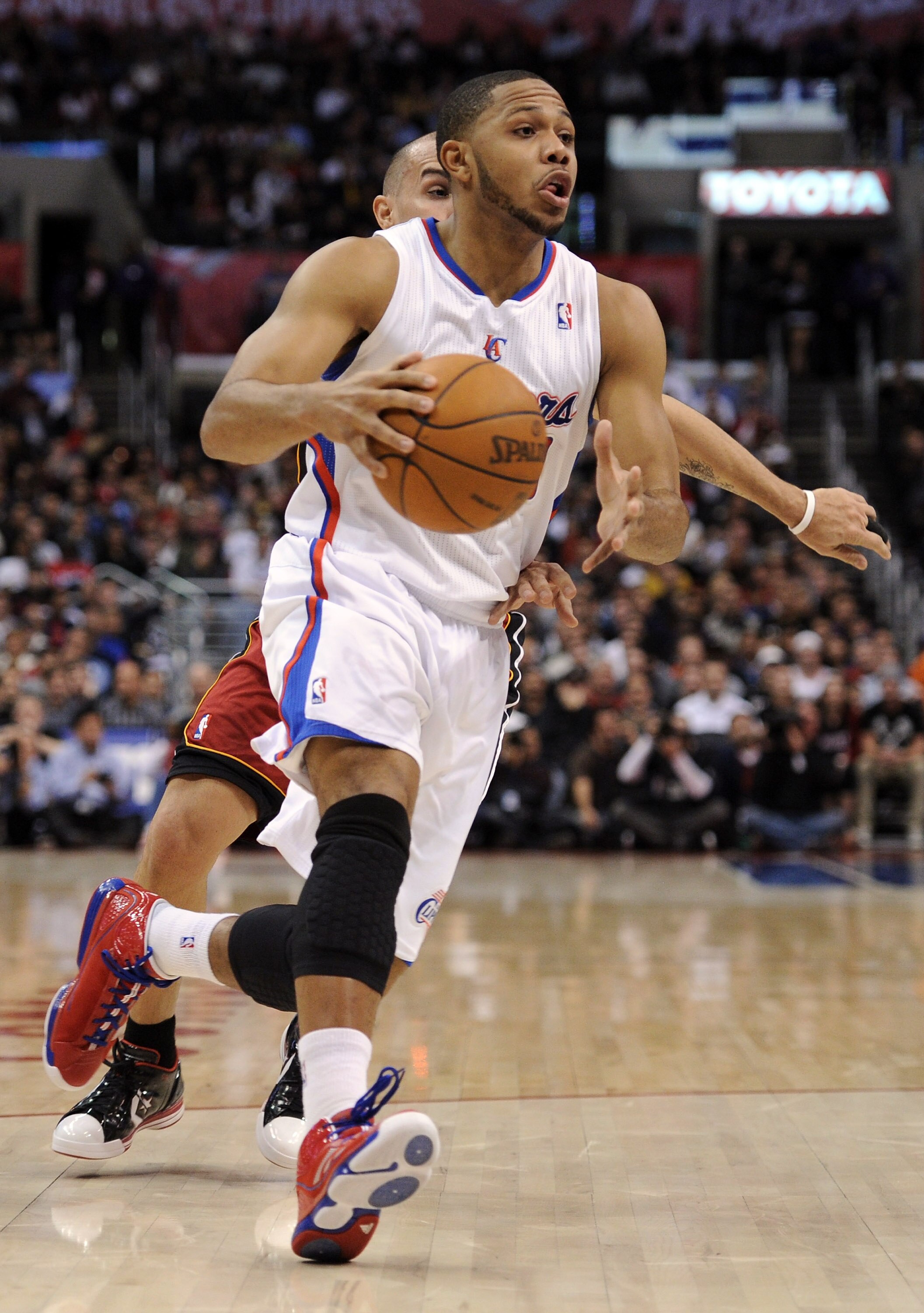 LOS ANGELES, CA - JANUARY 12:  Eric Gordon #10 of the Los Angeles Clippers heads to the basket in front of Carlos Arroyo #8 of the Miami Heat at Staples Center on January 12, 2011 in Los Angeles, California.  NOTE TO USER: User expressly acknowledges and