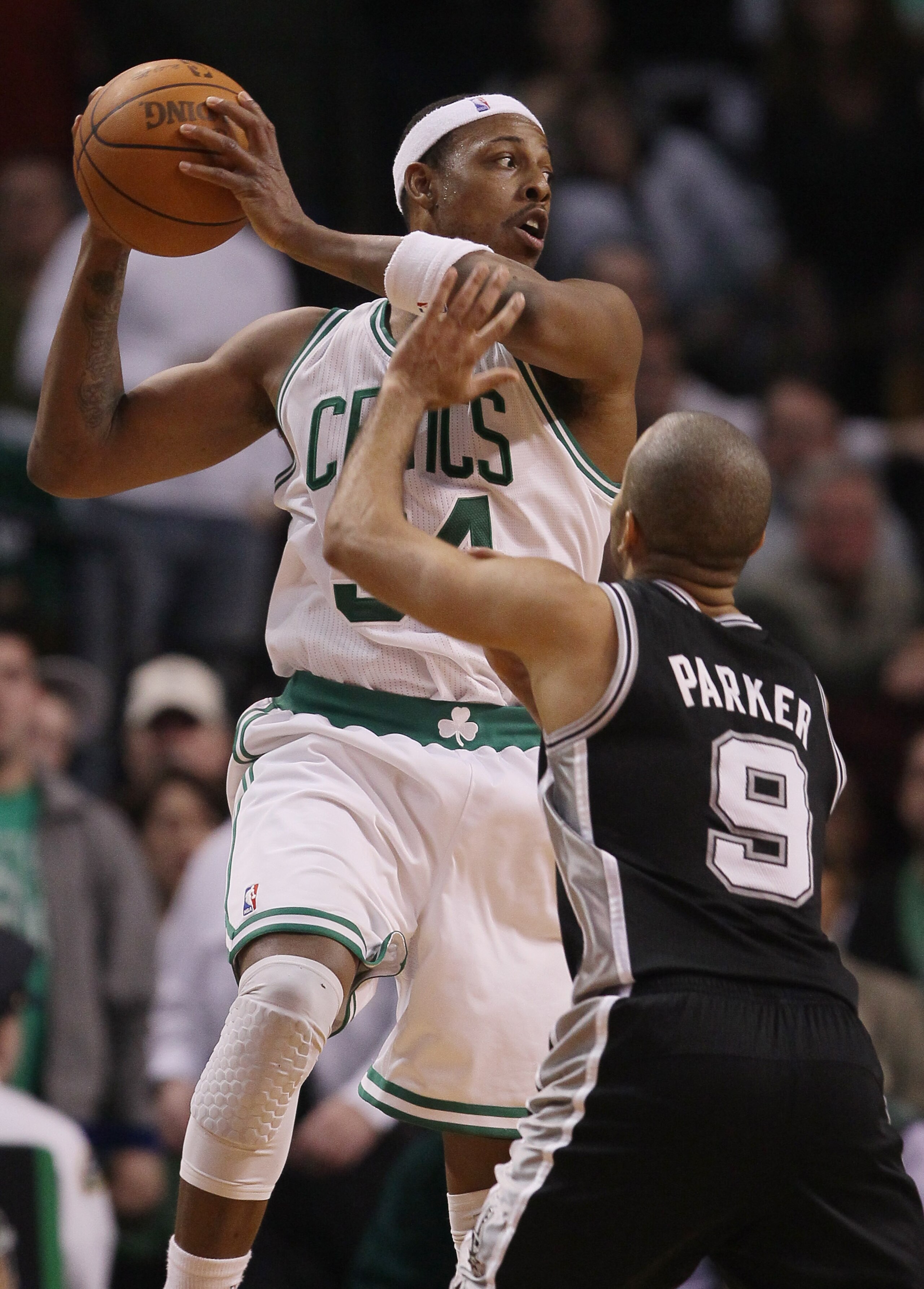 BOSTON, MA - JANUARY 05:  Paul Pierce #34 of the Boston Celtics looks to pass as Tony Parker #9 of the San Antonio Spurs defends on January 5, 2011 at the TD Garden in Boston, Massachusetts. The Celtics defeated the Spurs 105-103. NOTE TO USER: User expre