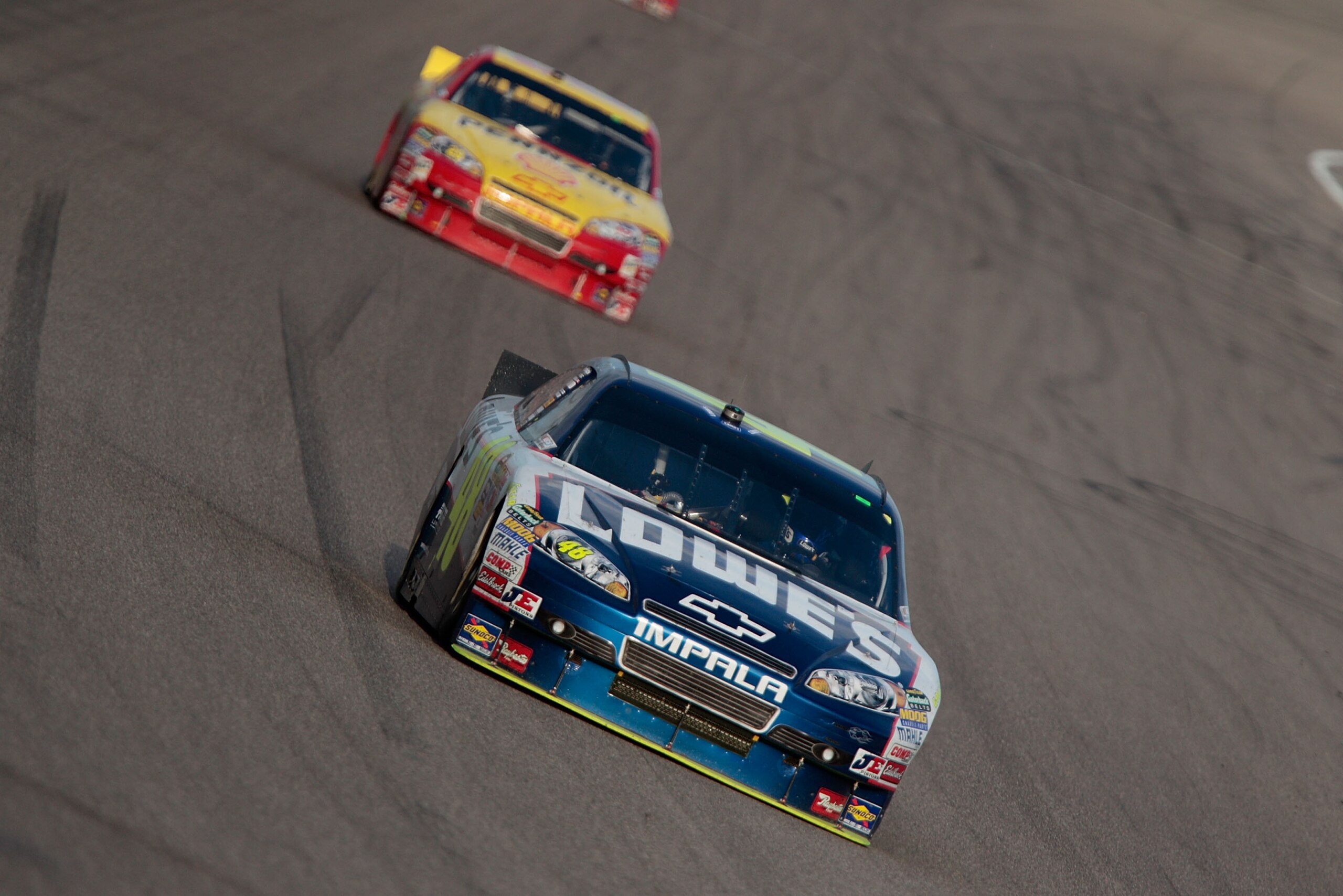 HOMESTEAD, FL - NOVEMBER 21:  Jimmie Johnson, driver of the #48 Lowe's Chevrolet, leads Kevin Harvick, driver of the #29 Shell/Pennzoil Chevrolet, during the NASCAR Sprint Cup Series Ford 400 at Homestead-Miami Speedway on November 21, 2010 in Homestead,
