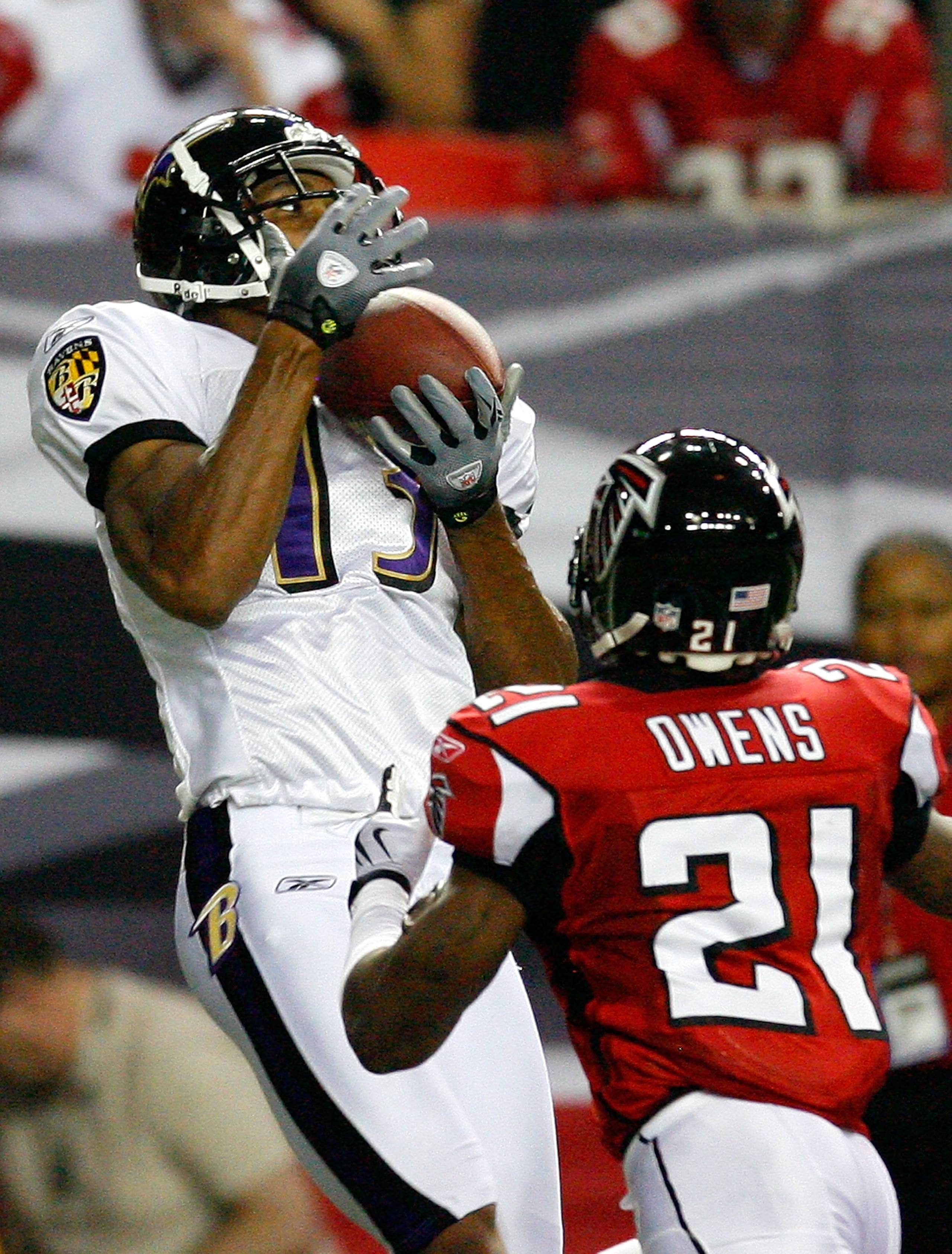 ATLANTA - SEPTEMBER 03:  Receiver Eron Riley #13 of the Baltimore Raves pulls in a reception against Christopher Owens #21 of the Atlanta Falcons at Georgia Dome on September 3, 2009 in Atlanta, Georgia.  (Photo by Kevin C. Cox/Getty Images)