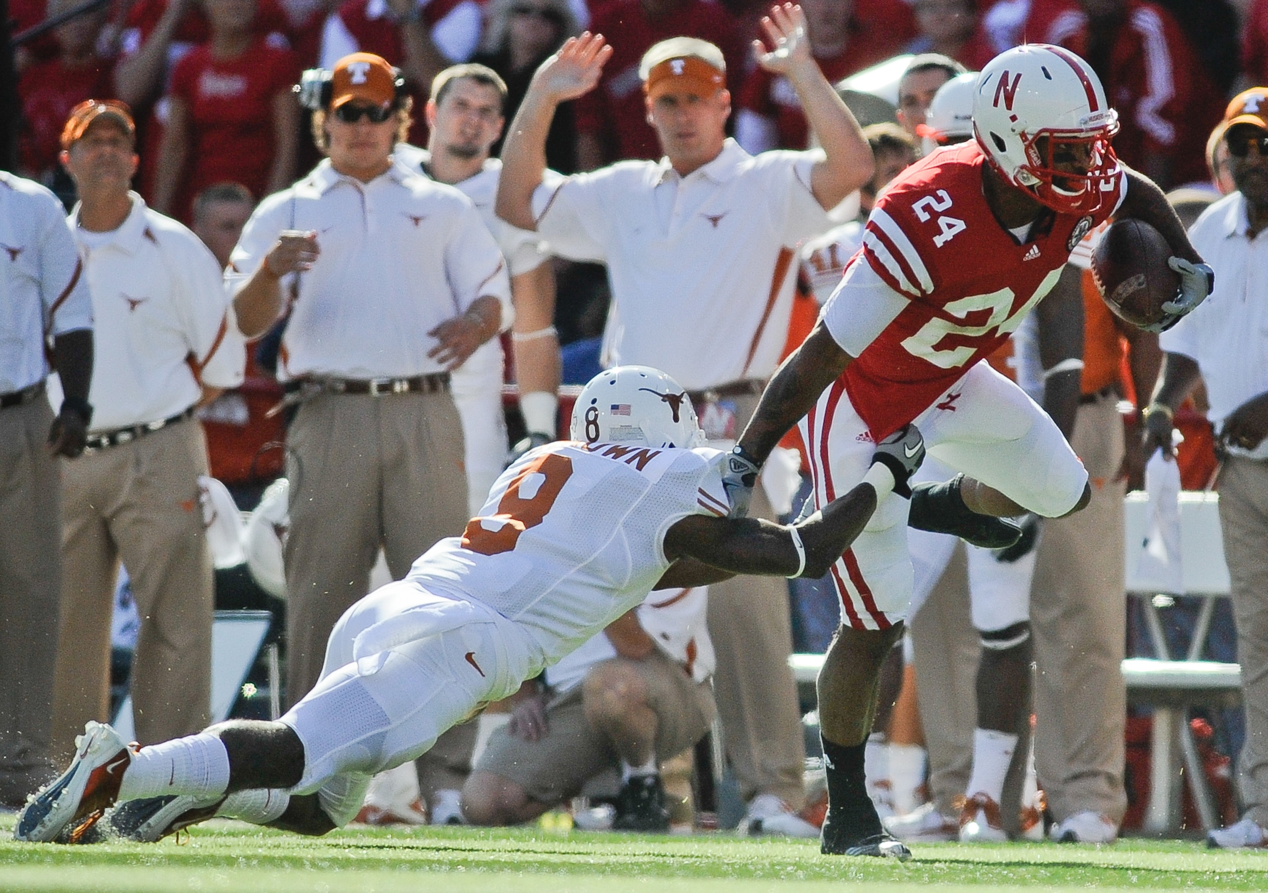 LINCOLN, NE - OCTOBER 16:  Wide receiver Niles Paul #24 of the Nebraska Cornhuskers tries to slip the grip defensive end Dravannti Johnson #9 of the Texas Longhorns during first half action of their game at Memorial Stadium on October 16, 2010 in Lincoln,