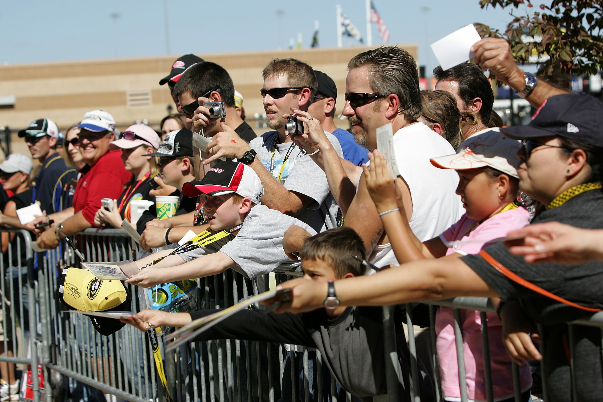 KANSAS CITY, KS - OCTOBER 01:  Fans look to get autographs during practice for the NASCAR Sprint Cup Series Price Chopper 400 on October 1, 2010 in Kansas City, Kansas.  (Photo by Christa Thomas/Getty Images for NASCAR)