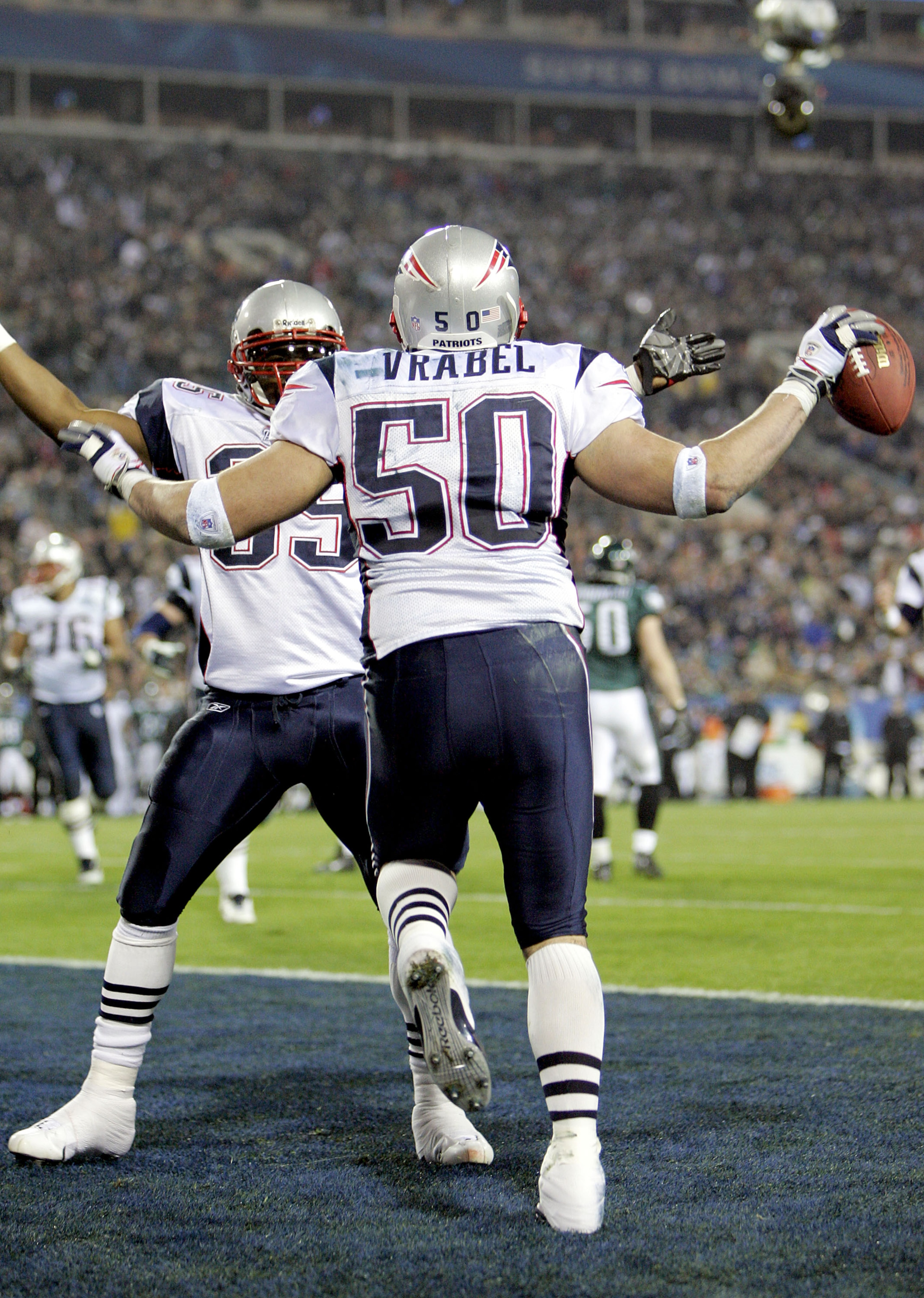 JACKSONVILLE, FL - FEBRUARY 06:  Linebacker Mike Vrabel #50 of the New England Patriots celebrates with teammate Patrick Pass #35 after Vrabel made a 2-yard touchdown reception against the Philadelphia Eagles in the third quarter during Super Bowl XXXIX a