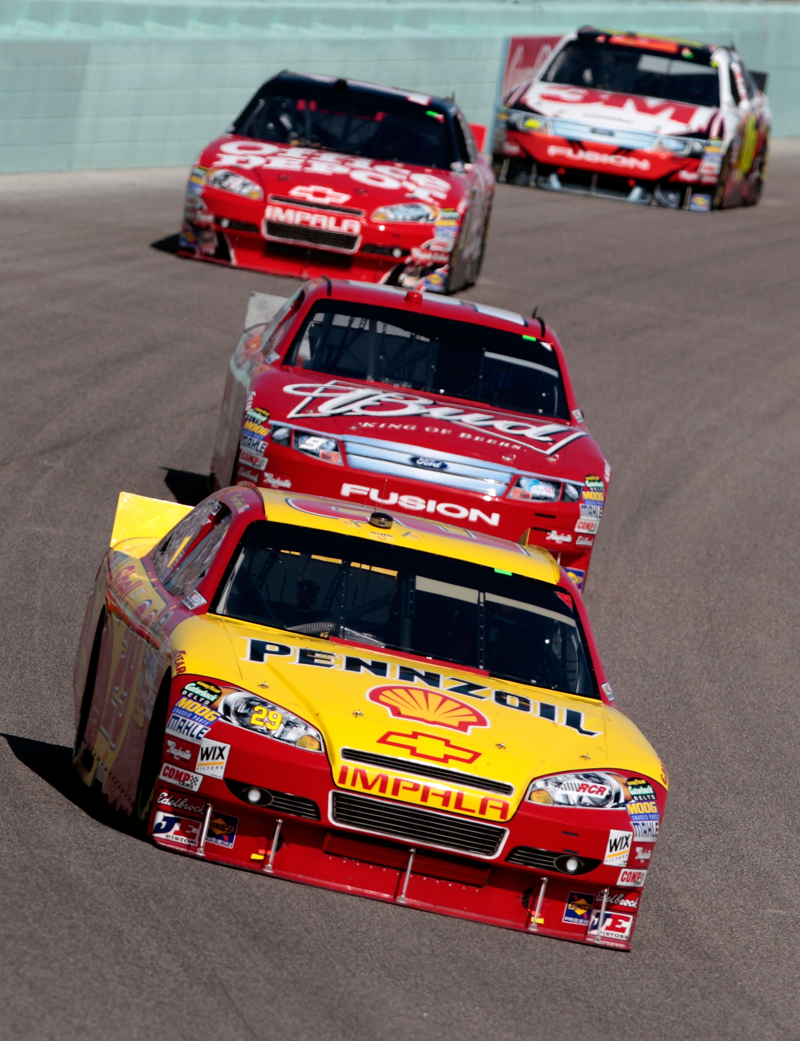 HOMESTEAD, FL - NOVEMBER 21:  Kevin Harvick, driver of the #29 Shell/Pennzoil Chevrolet, leads Aric Almirola, driver of the #9 Budweiser Ford, during the NASCAR Sprint Cup Series Ford 400 at Homestead-Miami Speedway on November 21, 2010 in Homestead, Flor
