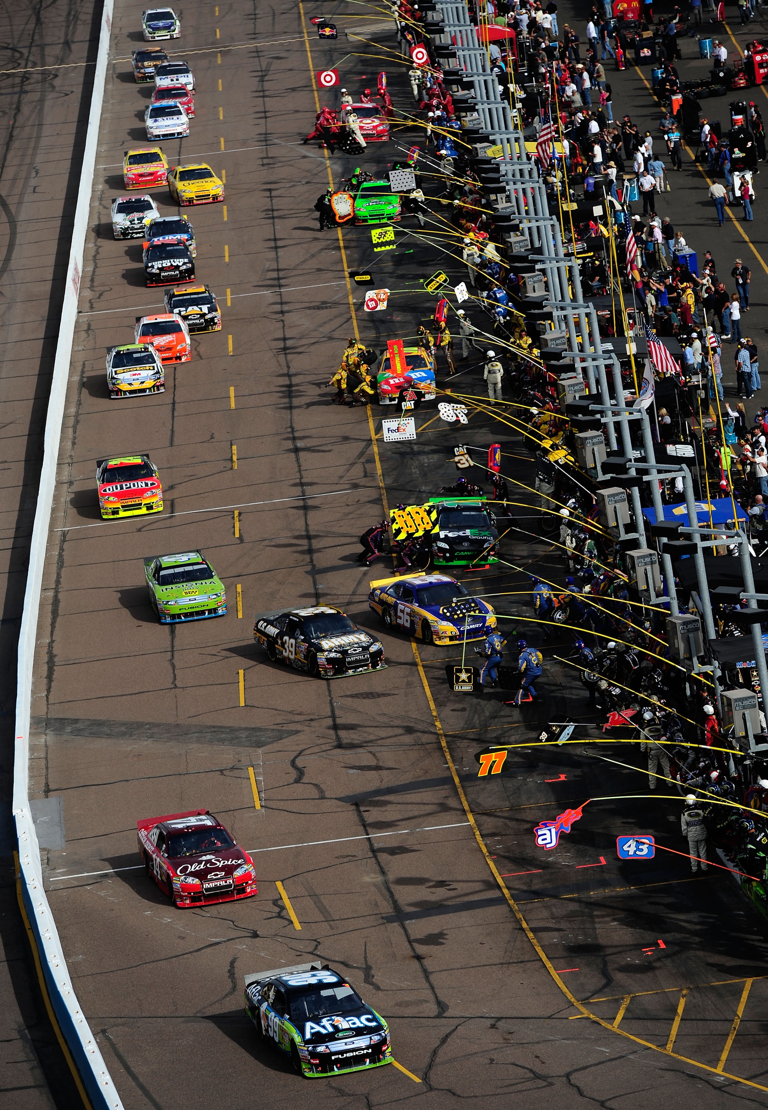 AVONDALE, AZ - NOVEMBER 14:  Carl Edwards, driver of the #99 Aflac Ford, leads cars off of pit road during the NASCAR Sprint Cup Series Kobalt Tools 500 at Phoenix International Raceway on November 14, 2010 in Avondale, Arizona.  (Photo by Robert Laberge/