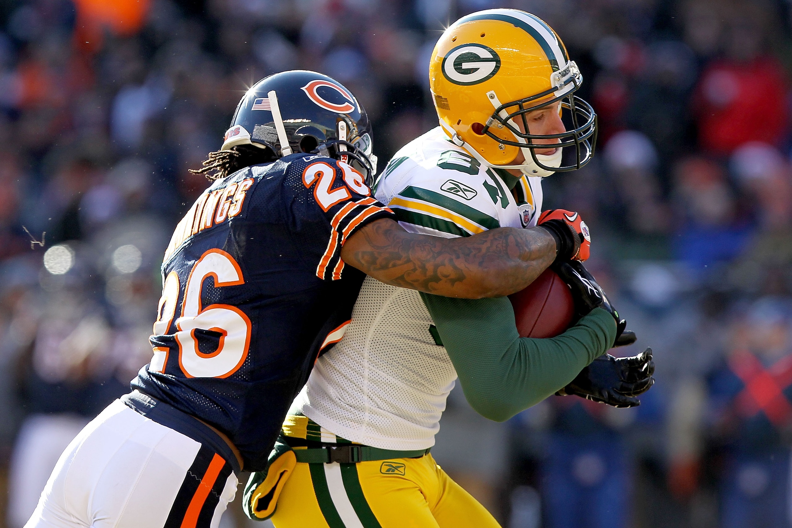 CHICAGO, IL - JANUARY 23:  Wide receiver Jordy Nelson #87 of the Green Bay Packers catches a 22-yard pass as he is tackled by Tim Jennings #26 of the Chicago Bears in the first quarter of the NFC Championship Game at Soldier Field on January 23, 2011 in C