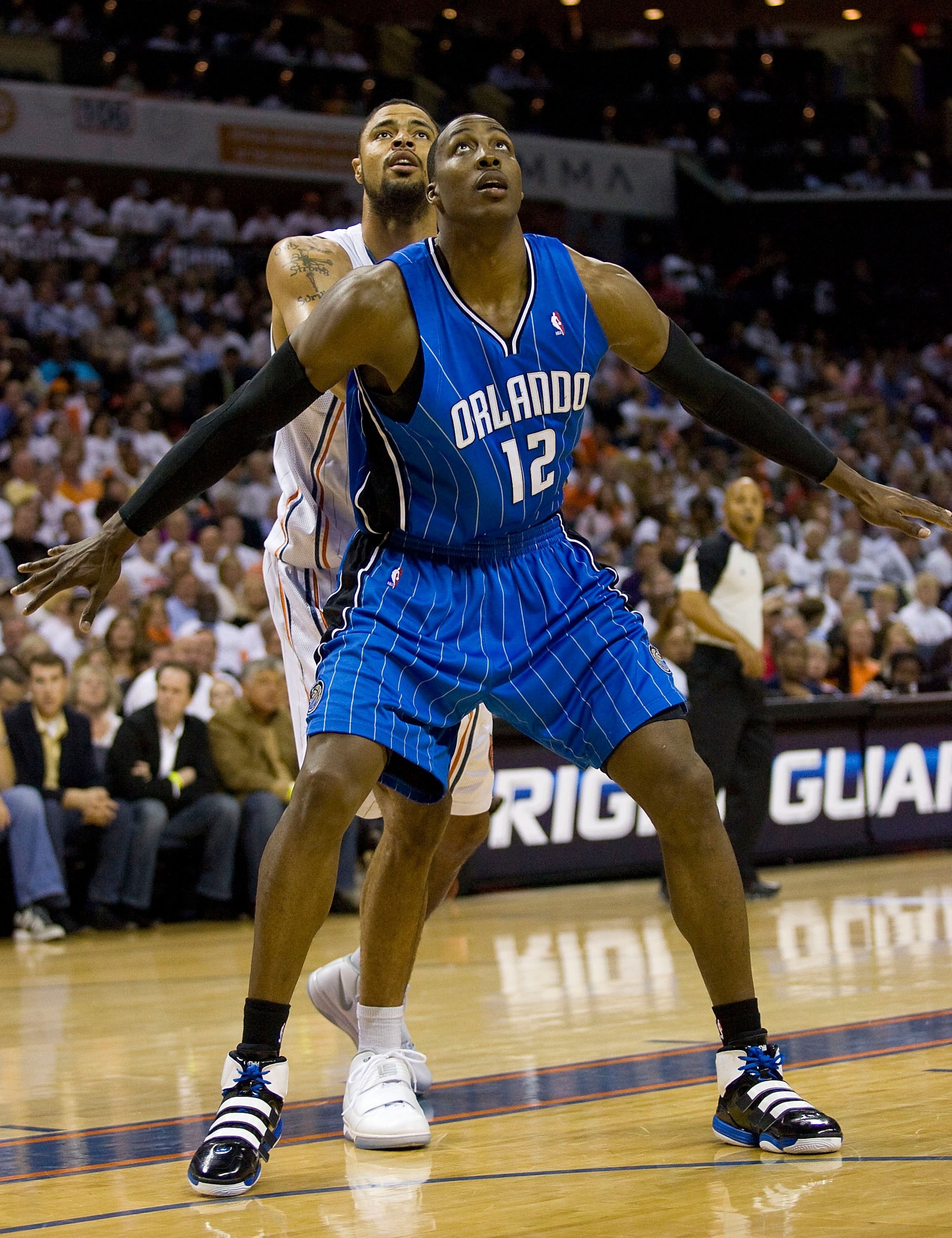 CHARLOTTE, NC - APRIL 26: Dwight Howard #12 of the Orlando Magic boxes out Tyson Chandler #6 of the Charlotte Bobcats at Time Warner Cable Arena on April 26, 2010 in Charlotte, North Carolina.  The Magic defeated the Bobcats 99-90 to complete the four gam