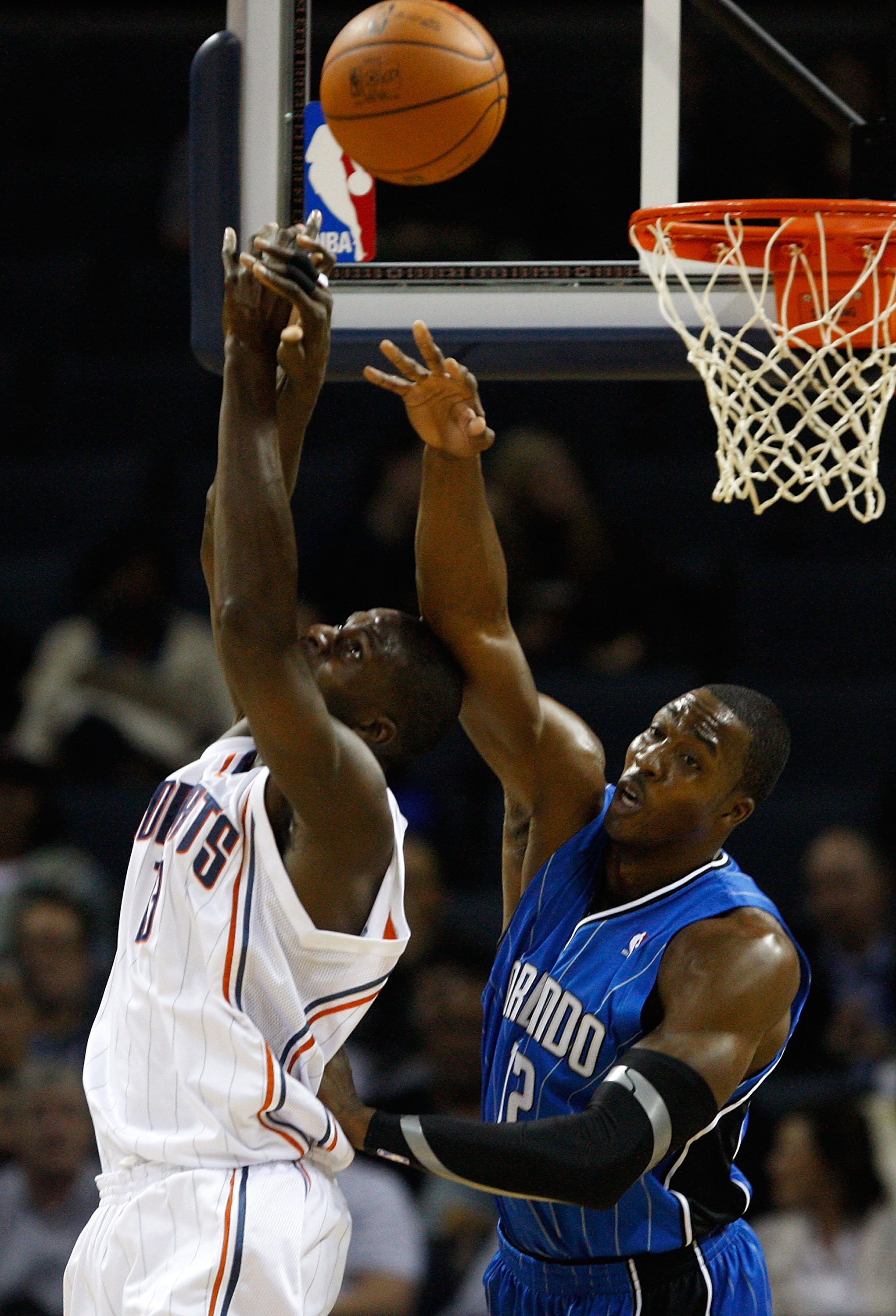 CHARLOTTE, NC - NOVEMBER 10:  Dwight Howard #12 of the Orlando Magic knocks the ball away from Nazr Mohammed #13 of the Charlotte Bobcats during their game at Time Warner Cable Arena on November 10, 2009 in Charlotte, North Carolina.  (Photo by Streeter L