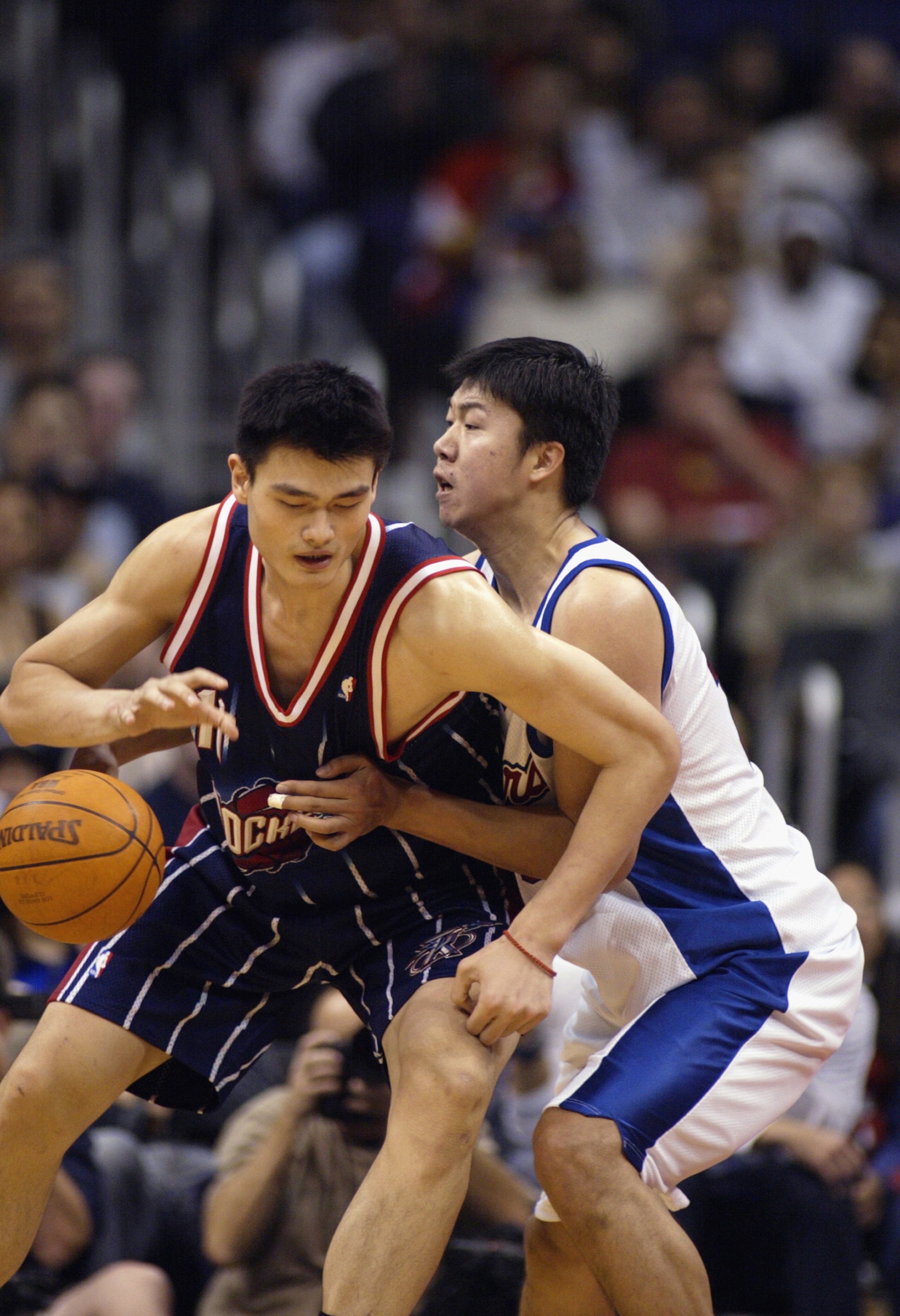LOS ANGELES - NOVEMBER 24: Yao Ming #11 of the Houston Rockets is defended by Zhizhi Wang #16 of the Los Angeles Clippers during the game at Staples Center on November 24, 2002 in Los Angeles, California. The Clippers won 90-89. NOTE TO USER: User expr LOS ANGELES - NOVEMBER 24: Yao Ming #11 of the Houston Rockets is defended by Zhizhi Wang #16 of the Los Angeles Clippers during the game at Staples Center on November 24, 2002 in Los Angeles, California. The Clippers won 90-89. NOTE TO USER: User expr