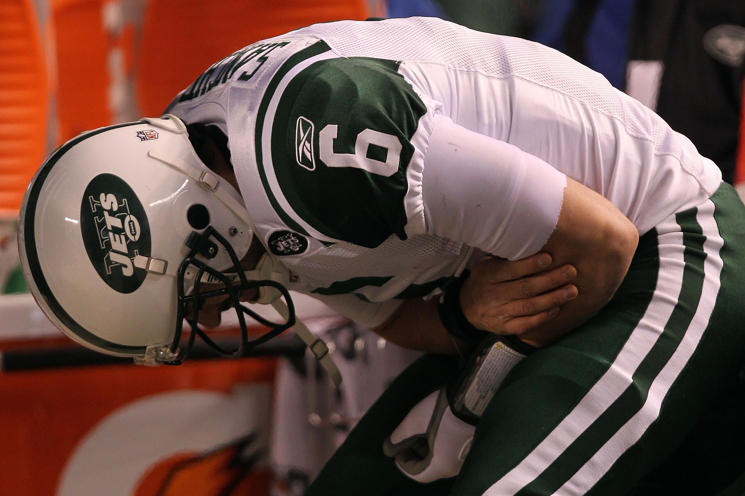PITTSBURGH, PA - JANUARY 23:  Mark Sanchez #6 of the New York Jets holds his arm on the sideline after fumbling the ball, which resulted in a second quarter Pittsburgh Steelers touchdown during the 2011 AFC Championship game at Heinz Field on January 23,