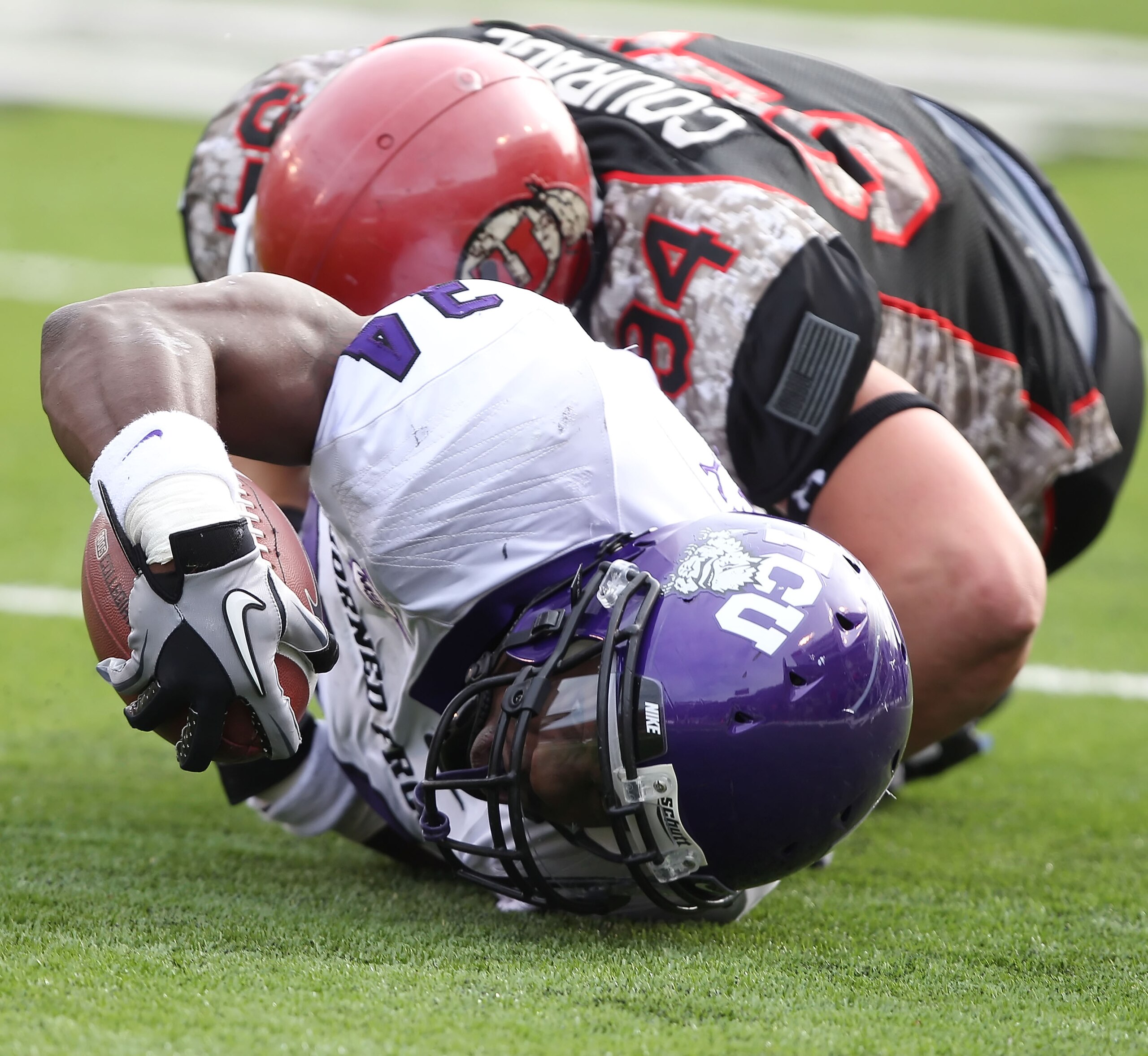 SALT LAKE CITY, UT - NOVEMBER 6: Ed Wesley #34 of the TCU Horned Frogs stretches the ball out after being tackled by Christian Cox #94 the Utah Utes during the second half of an NCAA Football game November 6, 2010 at Rice-Eccles Stadium in Salt Lake City, SALT LAKE CITY, UT - NOVEMBER 6: Ed Wesley #34 of the TCU Horned Frogs stretches the ball out after being tackled by Christian Cox #94 the Utah Utes during the second half of an NCAA Football game November 6, 2010 at Rice-Eccles Stadium in Salt Lake City,
