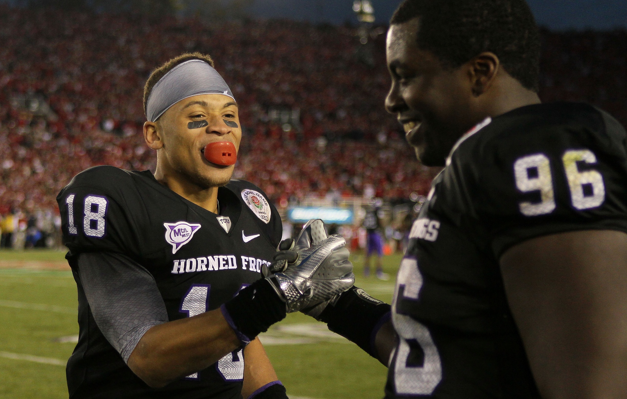 PASADENA, CA - JANUARY 01: Cornerback Travaras Battle #18 of the TCU Horned Frogs celebrates with Wayne Daniels #96 in the final moments of their 21-19 win over the Wisconsin Badgers in the 97th Rose Bowl game on January 1, 2011 in Pasadena, California. PASADENA, CA - JANUARY 01: Cornerback Travaras Battle #18 of the TCU Horned Frogs celebrates with Wayne Daniels #96 in the final moments of their 21-19 win over the Wisconsin Badgers in the 97th Rose Bowl game on January 1, 2011 in Pasadena, California.