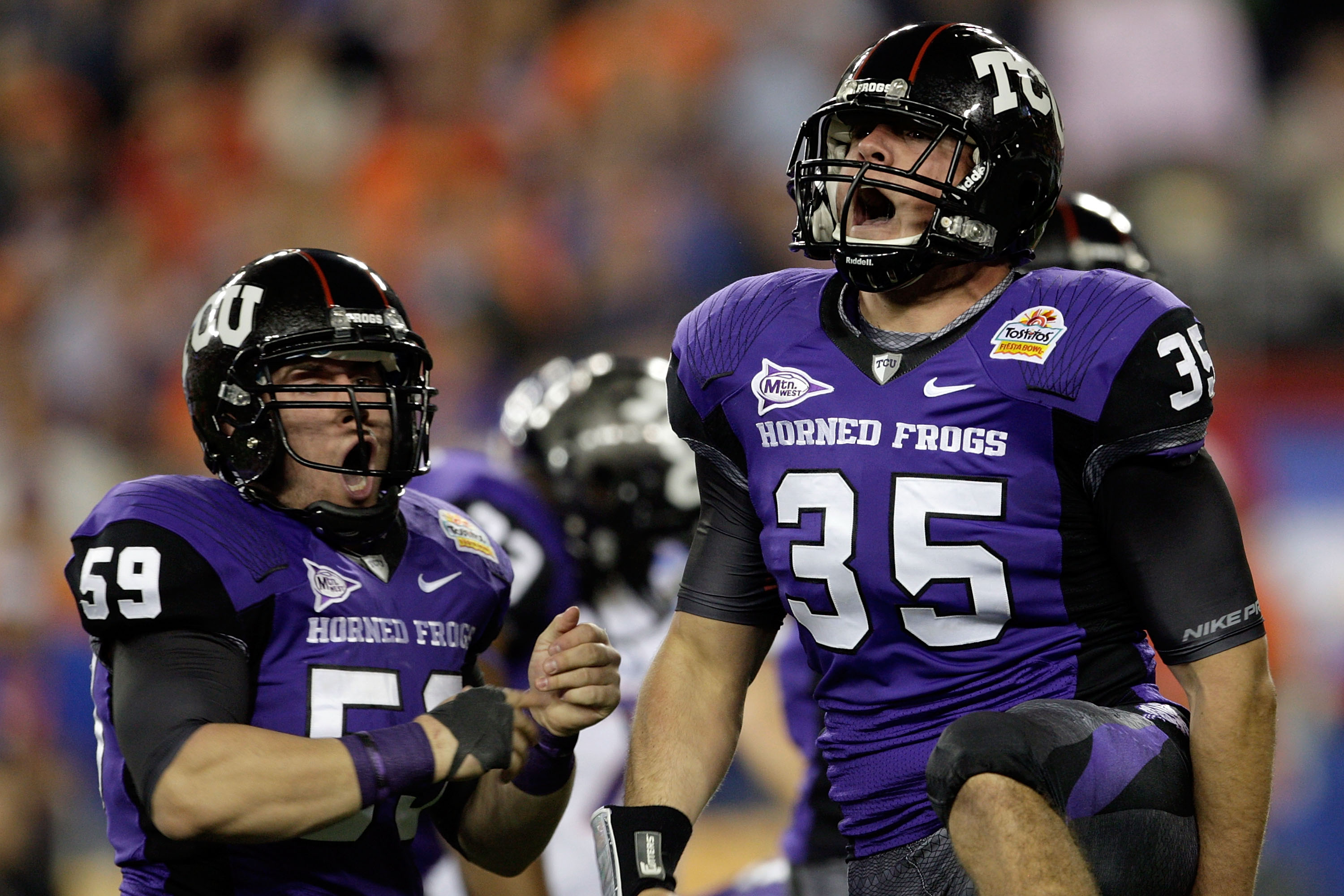 GLENDALE, AZ - JANUARY 04:  (R-L) Tanner Brock #35 and Logan Sligar #59 of the TCU Horned Frogs react after making a tackle in the first half against the Boise State Broncos during the Tostitos Fiesta Bowl at the Universtity of Phoenix Stadium on January