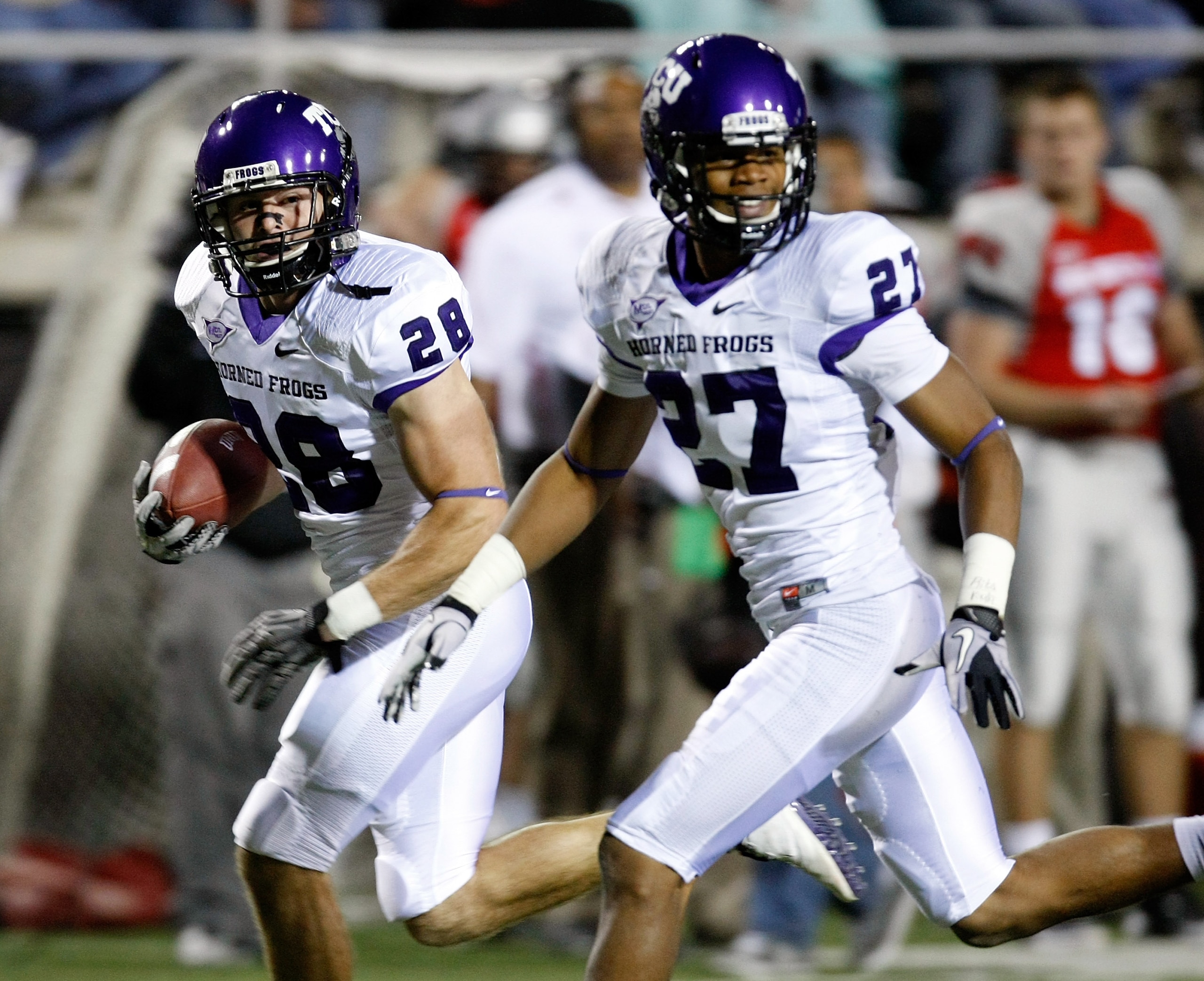 LAS VEGAS - OCTOBER 30: Colin Jones #28 of the Texas Christian University Horned Frogs runs for a 30-yard touchdown after making an interception against the UNLV Rebels as his teammate Jason Teague #27 runs with him during the second quarter of their gam LAS VEGAS - OCTOBER 30: Colin Jones #28 of the Texas Christian University Horned Frogs runs for a 30-yard touchdown after making an interception against the UNLV Rebels as his teammate Jason Teague #27 runs with him during the second quarter of their gam