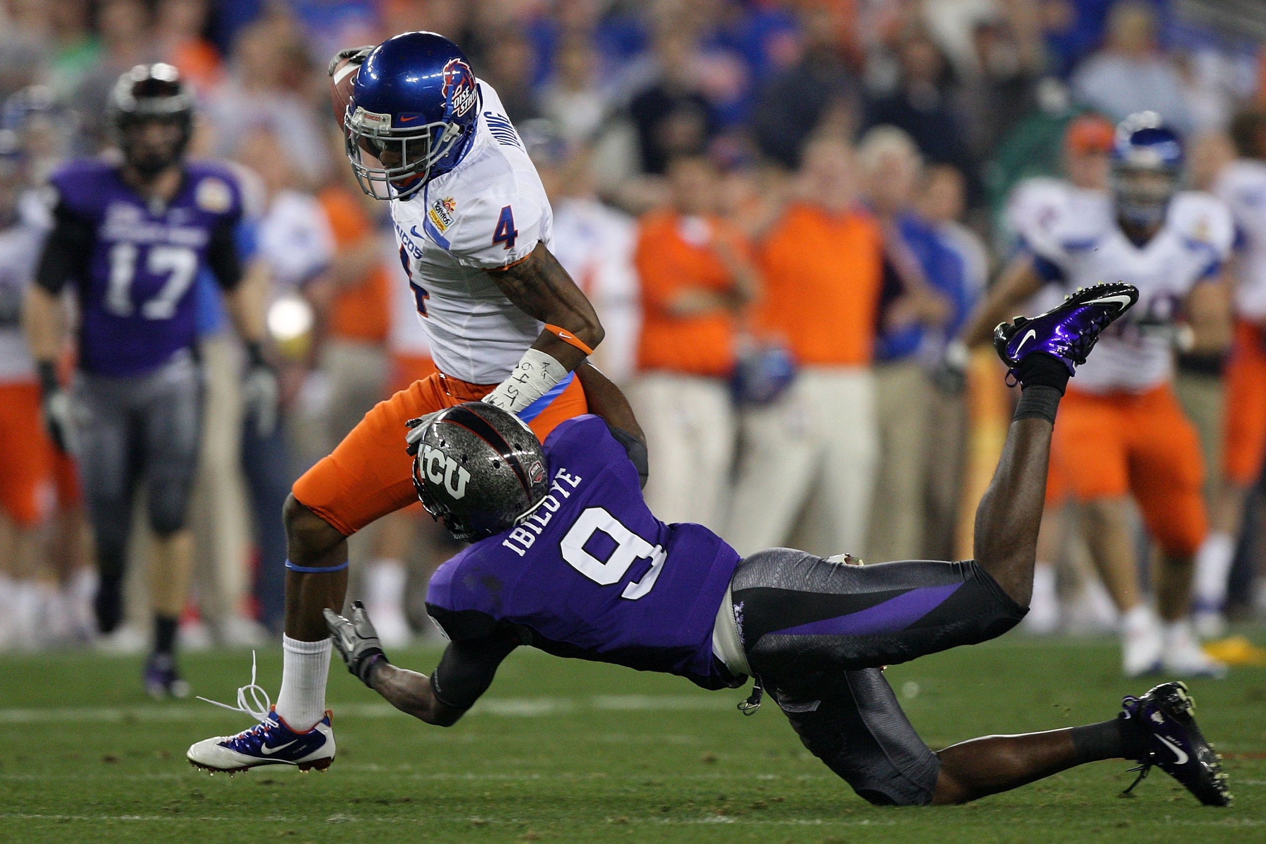 GLENDALE, AZ - JANUARY 04: Titus Young #4 of the Boise State Broncos runs after a catch as Alex Ibiloye #9 of the TCU Horned Frogs dives after him in the first half during the Tostitos Fiesta Bowl at the Universtity of Phoenix Stadium on January 4, 2010 GLENDALE, AZ - JANUARY 04: Titus Young #4 of the Boise State Broncos runs after a catch as Alex Ibiloye #9 of the TCU Horned Frogs dives after him in the first half during the Tostitos Fiesta Bowl at the Universtity of Phoenix Stadium on January 4, 2010