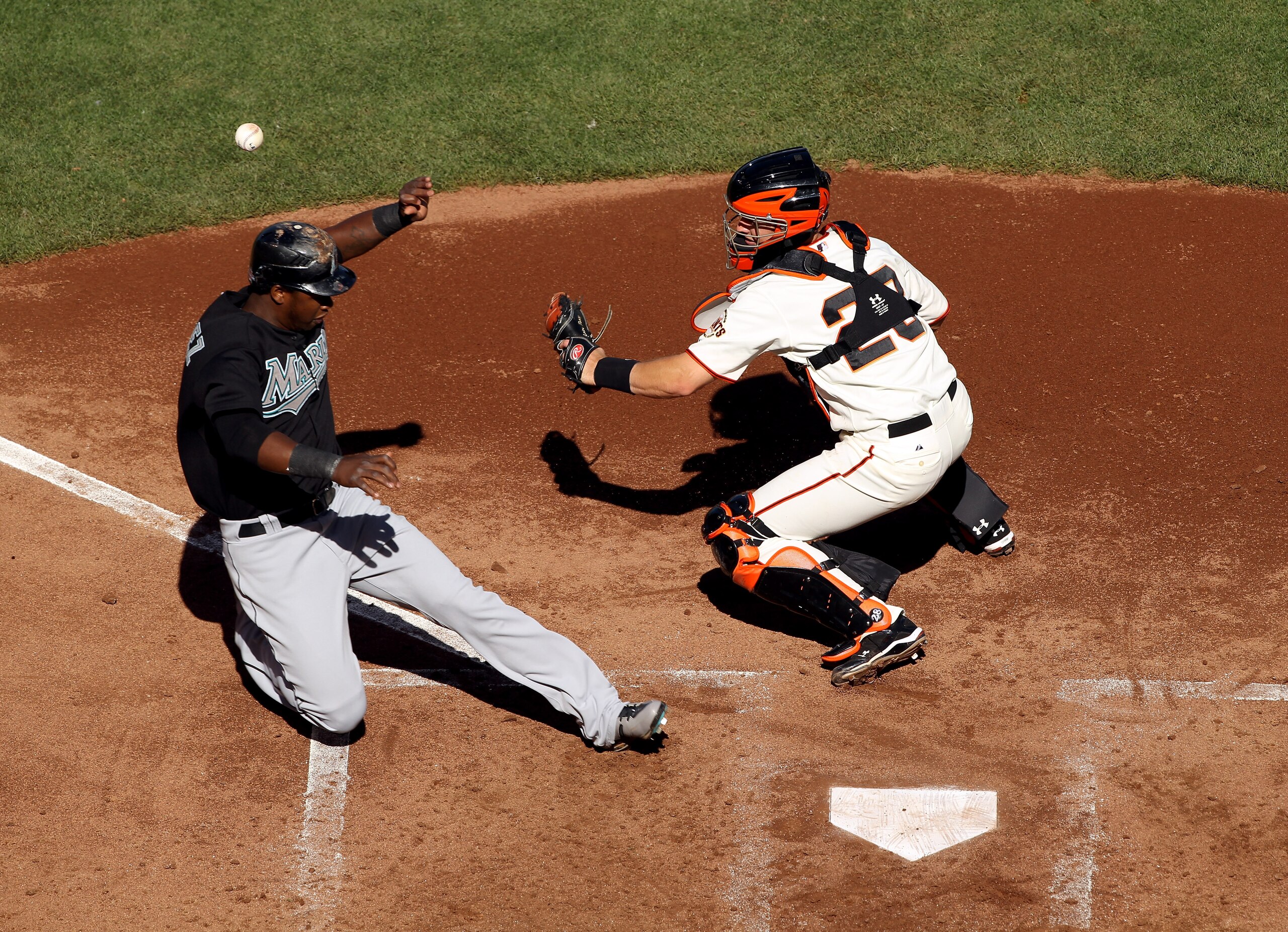SAN FRANCISCO - JULY 28:  Hanley Ramirez #2 of the Florida Marlins scores on a double by Logan Morrison #20 after the ball got away from Buster Posey #28 of the San Francisco Giants at AT&T Park on July 28, 2010 in San Francisco, California.  (Photo by Ez
